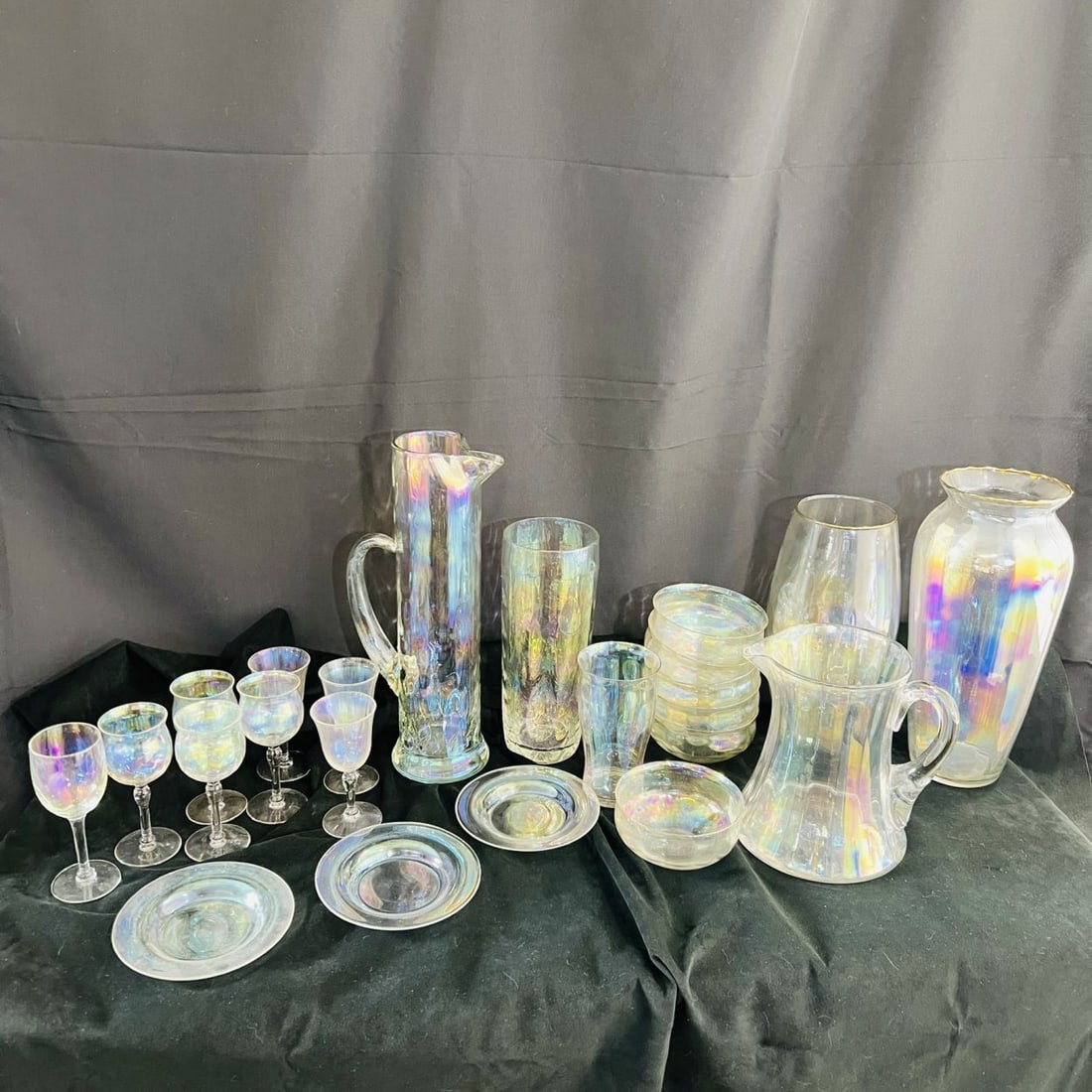 Iridescent Pitchers, Vases and Glassware: A Collection of Iridescent Glassware, Including two pitchers, six cordial glasses, six dessert bowls, three dessert plates, three vases and one glass. From the Estate of John A. Davidson, Jr. Proceeds