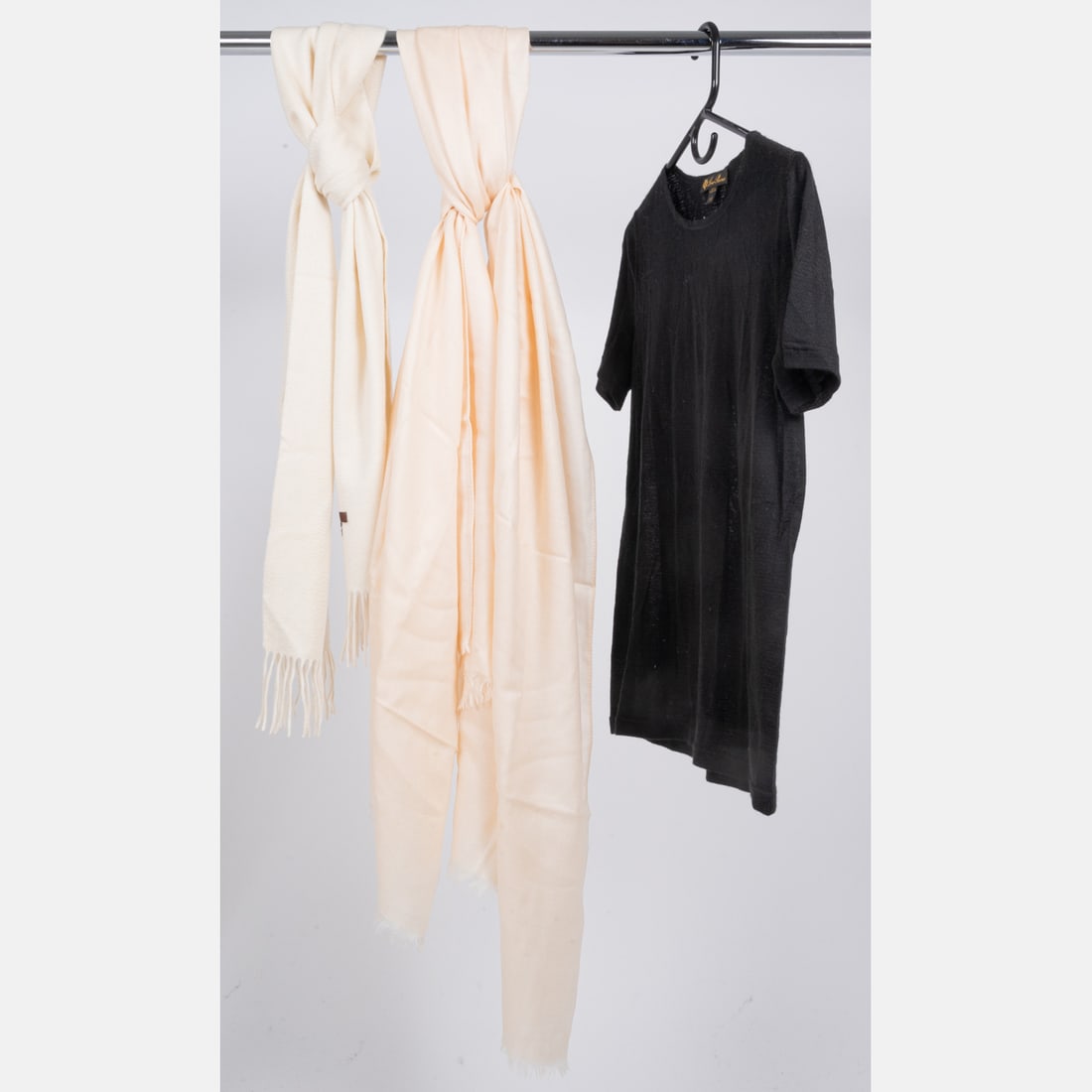 Two Loro Piana Cashmere Articles: Two Loro Piana Cashmere Articles, Loro Piana ivory colored lightweight cashmere scarf with fringe at either end. No fabric tag. Dimensions: 31 x 82 in. Loro Piana black short sleeve lightweight cashme