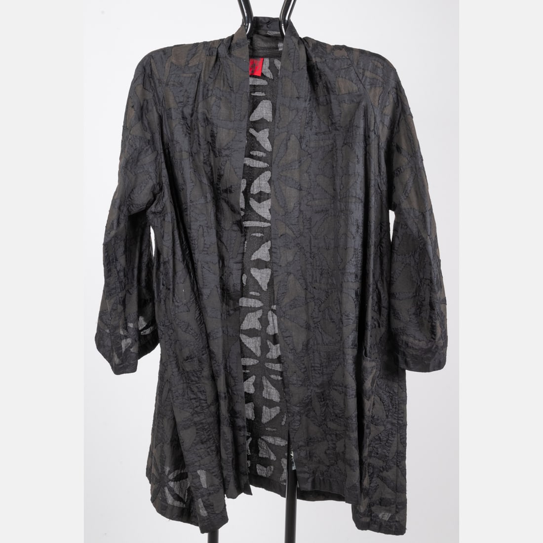 Mieko Mintz Open Front Tunic Top: A Mieko Mintz Open Front Tunic Top, Black tunic top with an open front design. Two front pockets. Geometric applique pattern in silky feeling fabric. No fabric or size tag; appliques feel like silk on