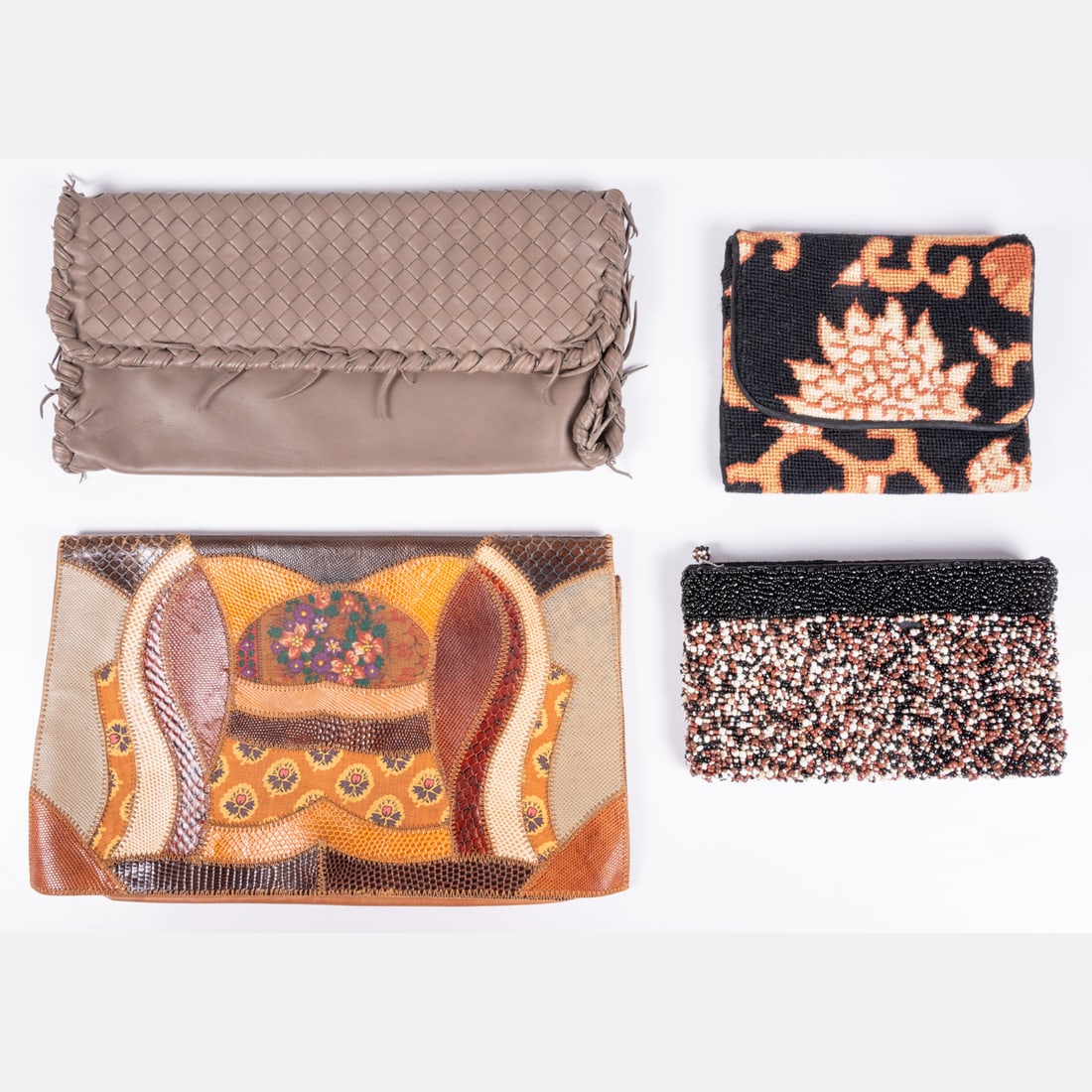 Four Clutch Bags: Four Clutch Bags, The first, a patchwork leather and fabric clutch by Furst & Mooney. Suede interior lining, snap closure. The second, a woven gray leather clutch with double magnetic flap closure. Su