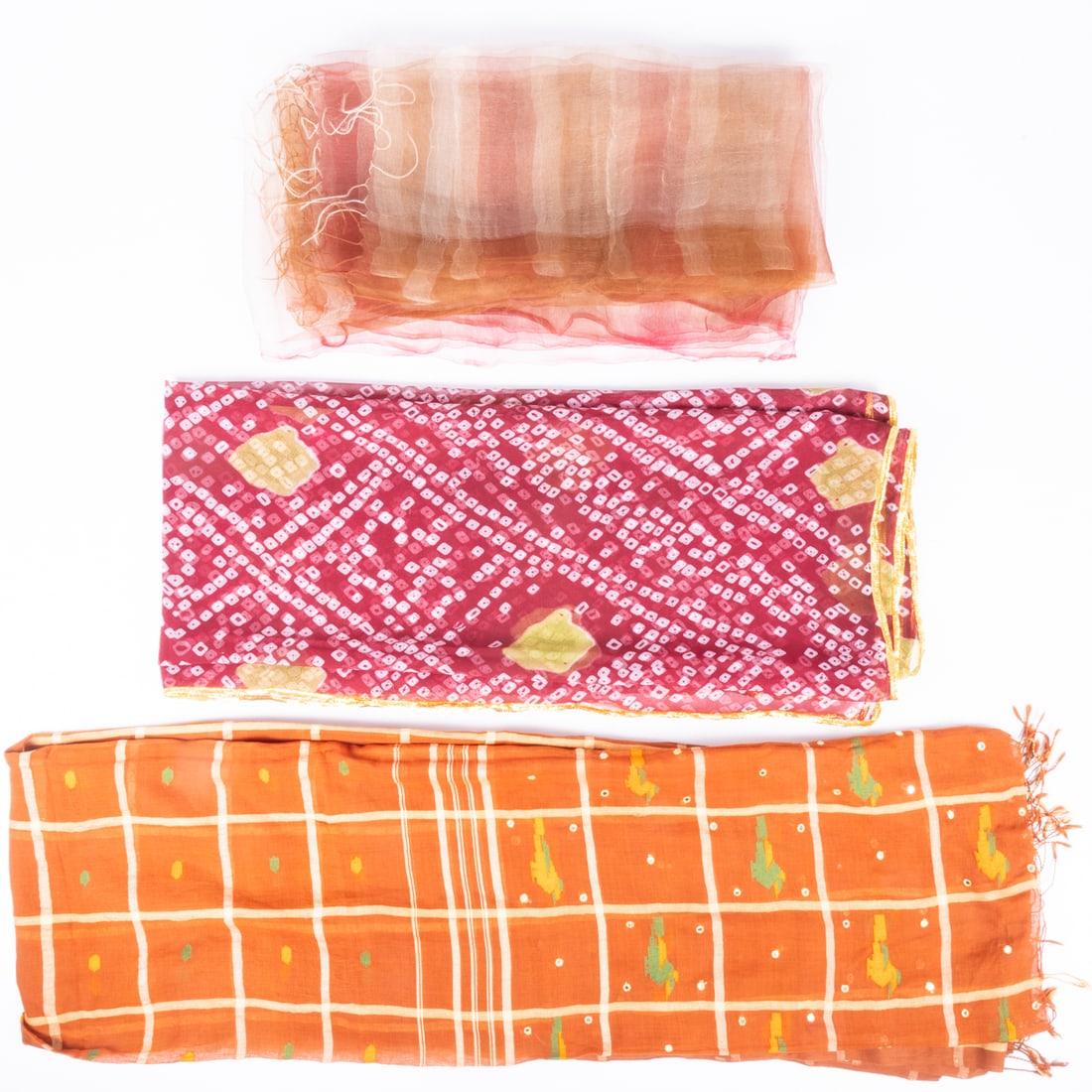 Three Ladies Scarves: Three Ladies Scarves, A brightly printed wine red, white and green scarf with a gold metallic border. No fabric content tag; feels like silk chiffon. Dimensions: 54 x 84 in. A brown, green and gold pa