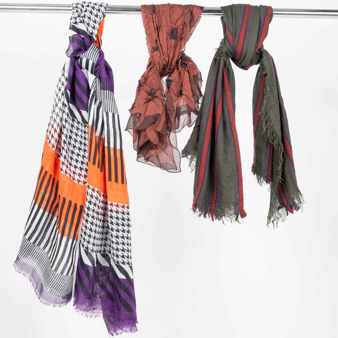 Three Ladies Scarves: Three Ladies Scarves, An orange, white, black and purple stripe, block print and houndstooth print scarf. Light weave - no fabric content tag - feels like cotton or cotton blend. Dimensions: 40 x 75 i