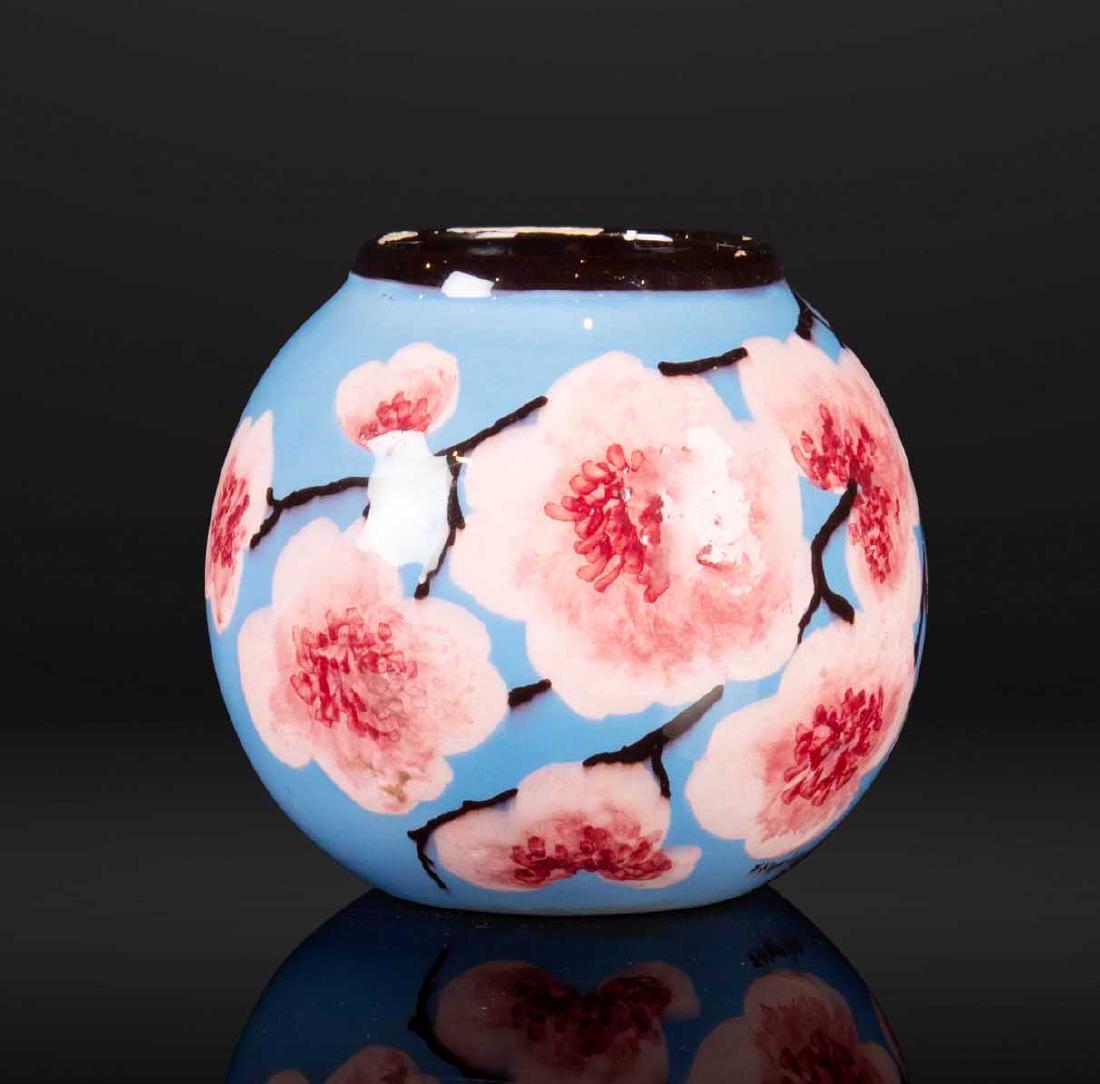 JE?ROME MASSIER (1850-1926) Vase de forme boule: JE?ROME MASSIER (1850-1926) Vase de forme boule Ce?ramique a? de?cor tournant de branches de pommier en fleurs sur fond de ciel azure?en. Manques sur le lisere? e?maille? noir du col. Signature J.Mass