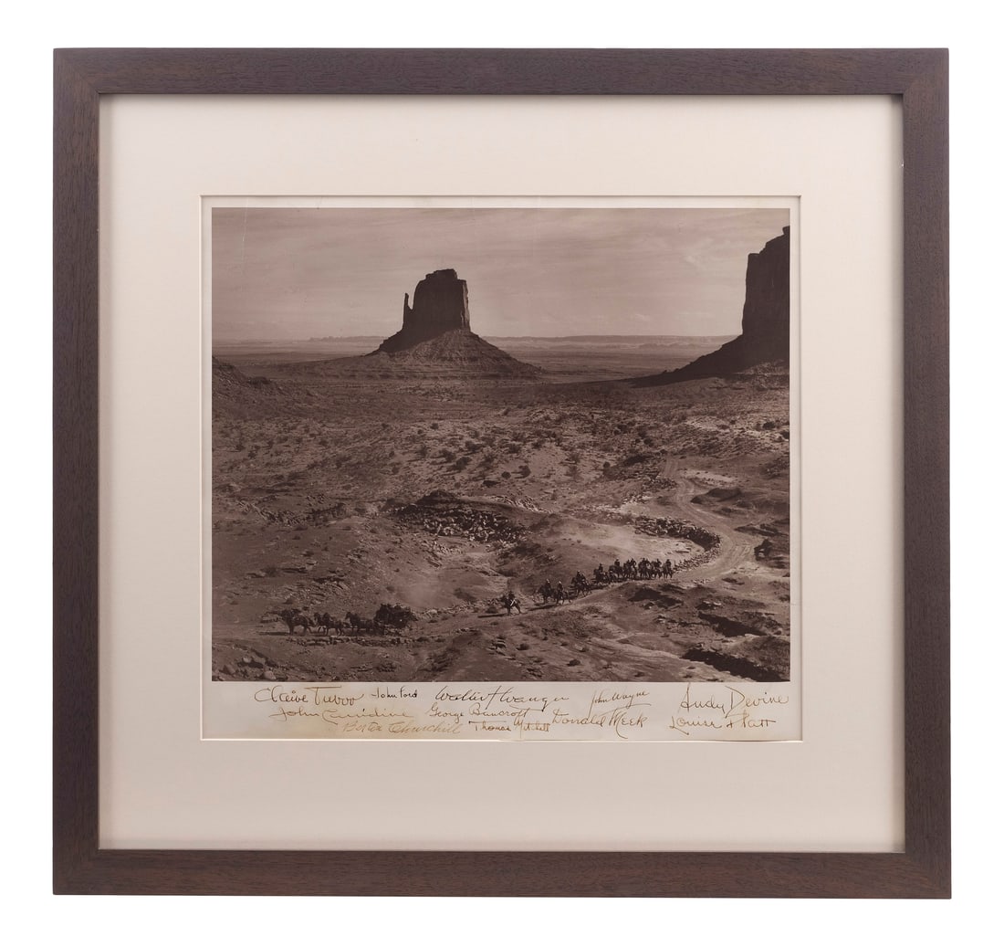 STAGECOACH (1939) - Cast-Autographed Framed Film Still: STAGECOACH (1939) - Cast-Autographed Framed Film Still - A cast-autographed framed film still from John Ford's Stagecoach. This gelatin silver photograph depicts the coach and escort traveling through