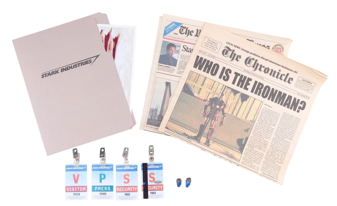 IRON MAN (2008) - Stark Industries File and Access Cards with Pairs of Production-Made Iron Man: IRON MAN (2008) - Stark Industries File and Access Cards with Pairs of Production-Made Iron Man (Robert Downey Jr.) Newspaper Cover and Sonic Taser Earplugs - A Stark Industries file and access cards