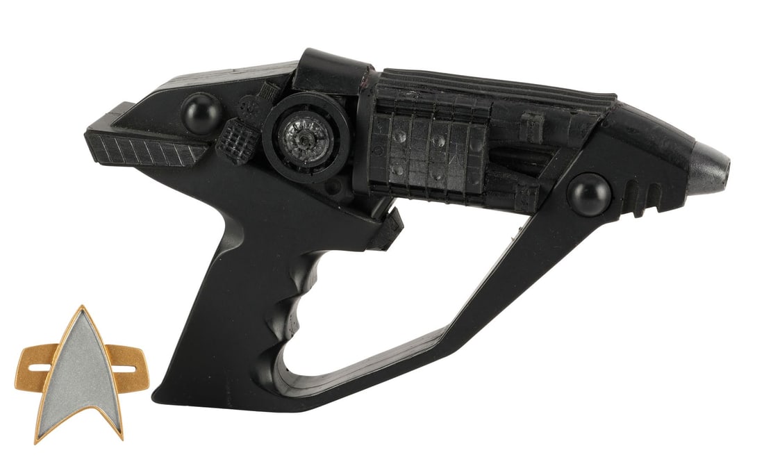 STAR TREK: VOYAGER (T.V. SERIES, 1995 - 2001) - Stunt "Live Fast and Prosper" Imposters Phaser with: STAR TREK: VOYAGER (T.V. SERIES, 1995 - 2001) - Stunt "Live Fast and Prosper" Imposters Phaser with Starfleet Combadge - A stunt imposters phaser with a Starfleet comm badge from Rick Berman's, Michae