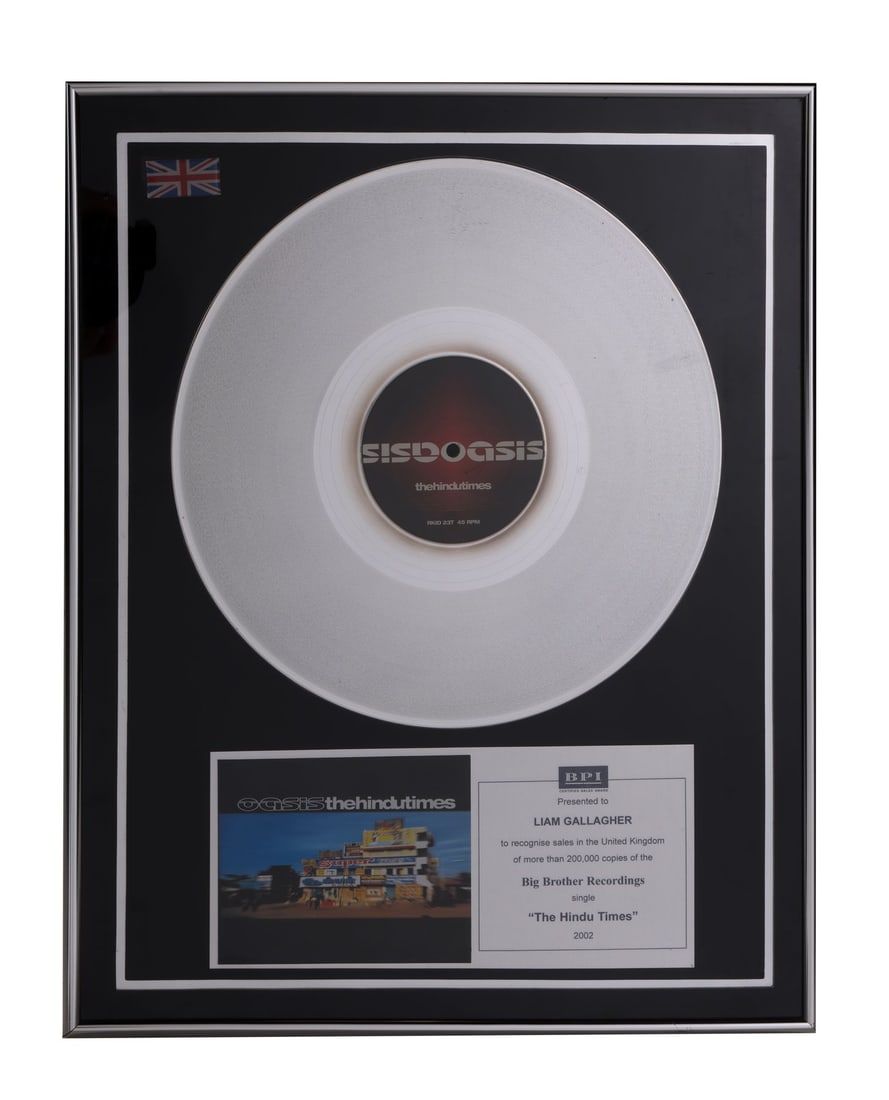 OASIS - The Hindu Times BPI Disc Award Presented to Liam Gallagher: OASIS - The Hindu Times BPI Disc Award Presented to Liam Gallagher - A BPI disc award presented to Liam Gallagher to commemorate over 200,000 UK sales of the Oasis single, "The Hindu Times". "The Hind