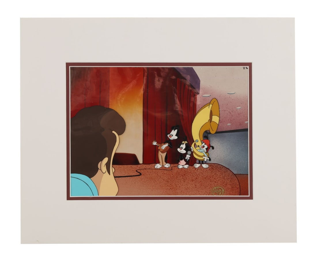 ANIMANIACS (TV SERIES, 1993-1998) - Yakko, Wakko and Dot Original Production Cel from "Pun For Hire": ANIMANIACS (TV SERIES, 1993-1998) - Yakko, Wakko and Dot Original Production Cel from "Pun For Hire" on Studio Printed Photographic Background Signed by Tom Ruegger - All three Warner siblings on stag