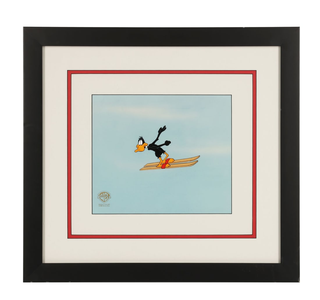 WARNER BROS. STUDIOS - Framed Daffy Skiiing Original Production Cel on Studio Printed Photographic: WARNER BROS. STUDIOS - Framed Daffy Skiiing Original Production Cel on Studio Printed Photographic Background - Daffy Duck flies high through open sky on a pair of water skis, arms flung up, still gri