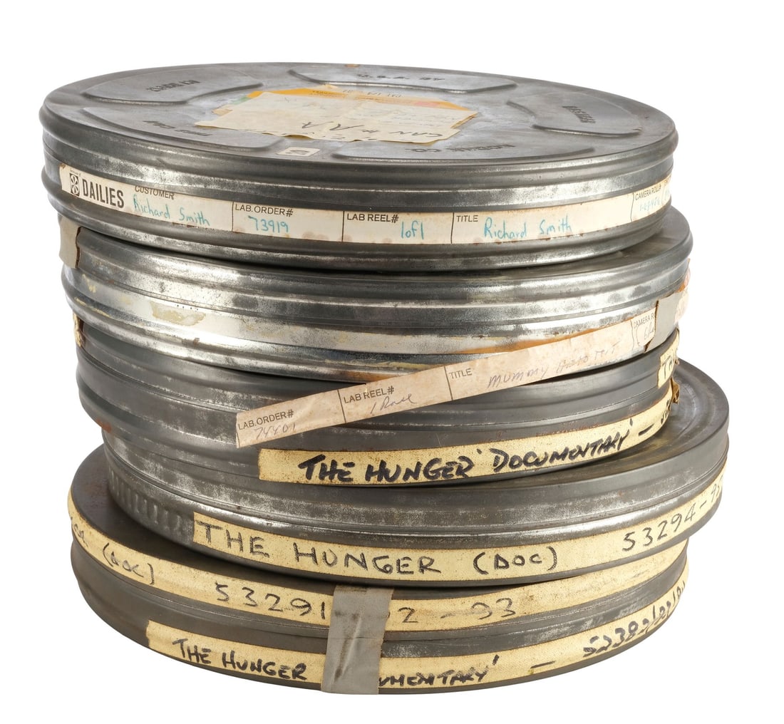 683. THE HUNGER (1983) - Dick Smith Collection: Set of 11 Reels of 16mm Behind-the-Scenes Footage: Bidding for this lot will end on Thursday, August 27th. The auction will begin at 9:30 AM (PDT) / 12:30 PM (EDT) / 5:30 PM (GMT) and lots are sold sequentially via live auctioneer; tune in to the live