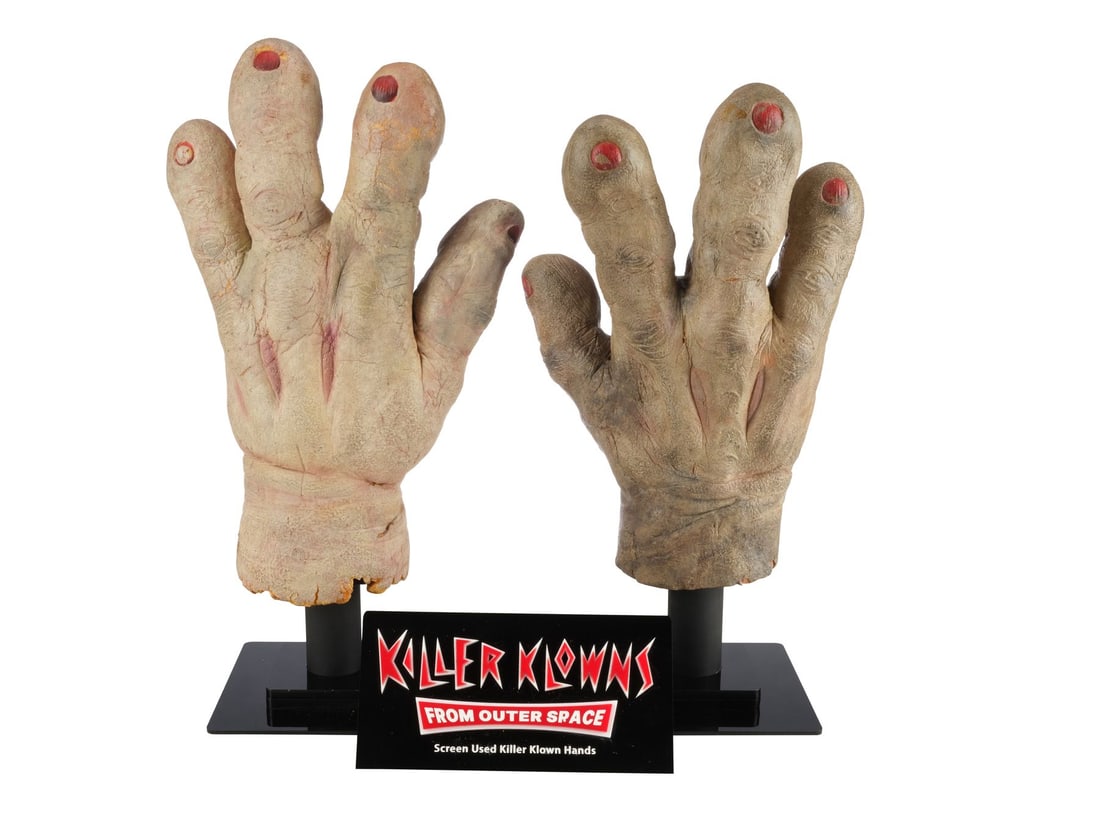 926. KILLER KLOWNS FROM OUTER SPACE (1988) - Pair of Klown Hands on Display: Bidding for this lot will end on Thursday, August 27th. The auction will begin at 9:30 AM (PDT) / 12:30 PM (EDT) / 5:30 PM (GMT) and lots are sold sequentially via live auctioneer; tune in to the