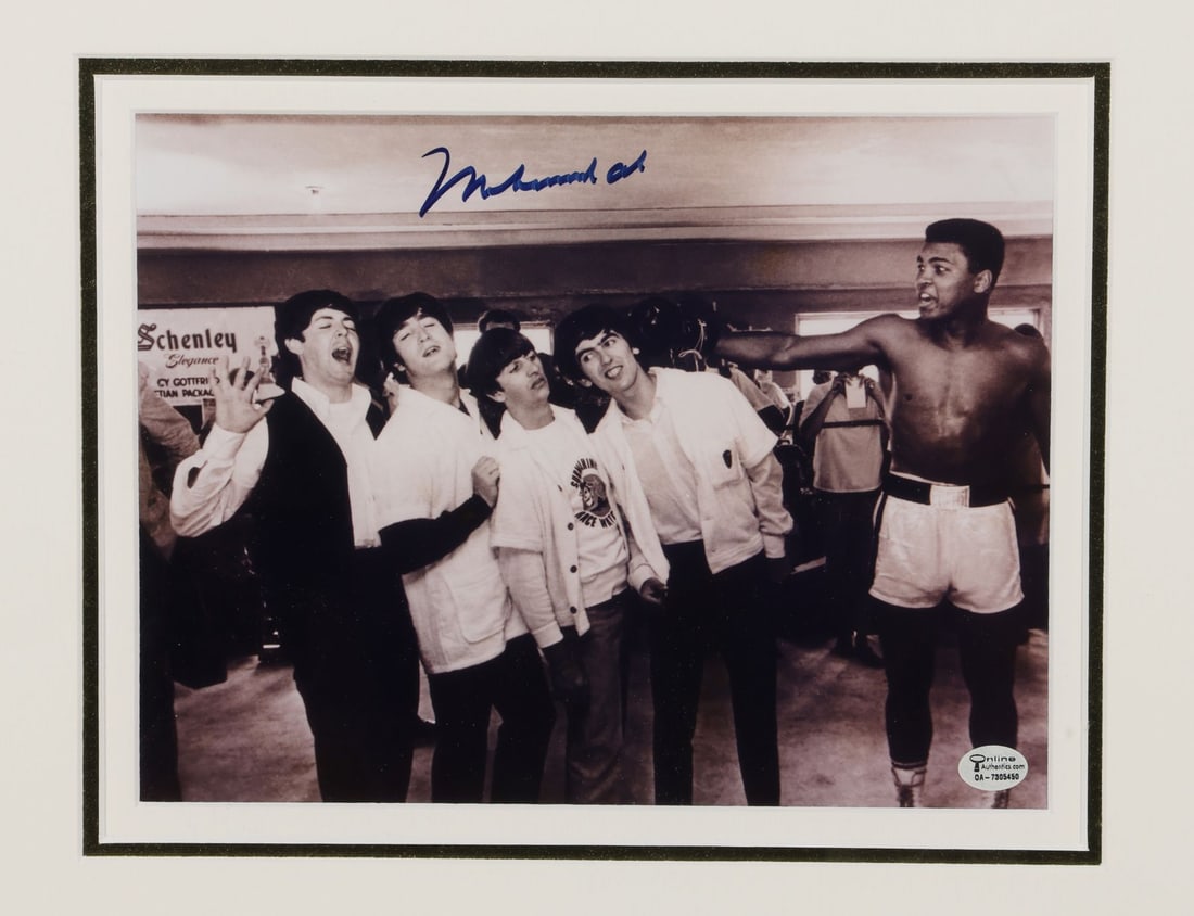 BEATLES, THE - Framed John Lennon, Paul McCartney, George Harrison and Ringo Starr-Autographed Page: BEATLES, THE - Framed John Lennon, Paul McCartney, George Harrison and Ringo Starr-Autographed Page and Muhammad Ali-Autographed Photograph A large piece of paper signed by all four members of The Bea