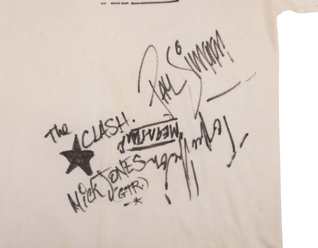 CLASH, THE - Joe Strummer, Mick Jones, Paul Simonon and Topper Headon-Autographed White T-Shirt from: CLASH, THE - Joe Strummer, Mick Jones, Paul Simonon and Topper Headon-Autographed White T-Shirt from Thebarton Theatre Concert, 1982 A white T-shirt autographed on the reverse by all four members of T