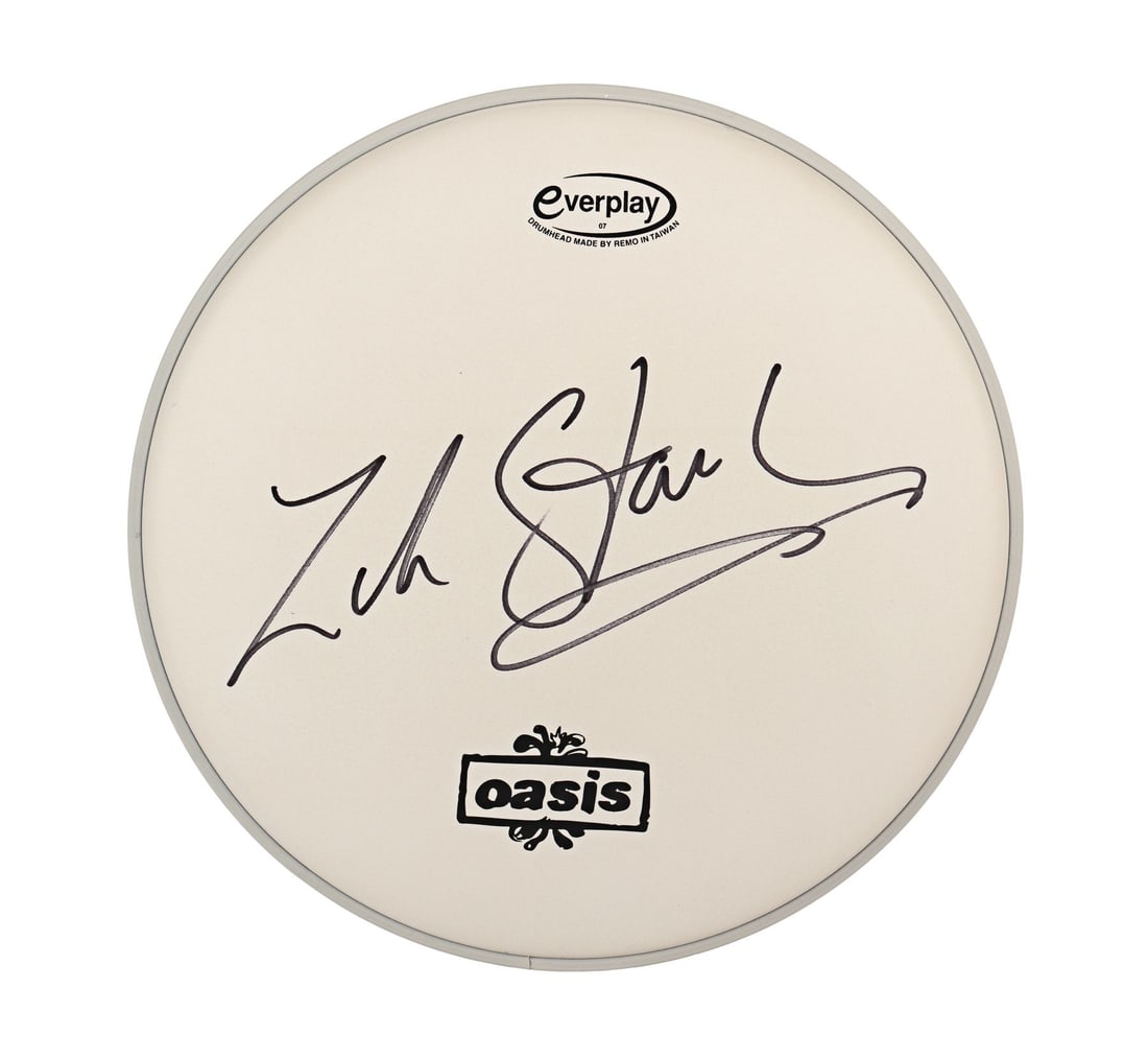 OASIS - Zak Starkey-Autographed Drumskin and Sticks: OASIS - Zak Starkey-Autographed Drumskin and Sticks A drumskin autographed by Oasis drummer Zak Starkey, accompanied by a pair of sticks. The son of Beatles drummer Ringo Starr, Zak Starkey, was the t