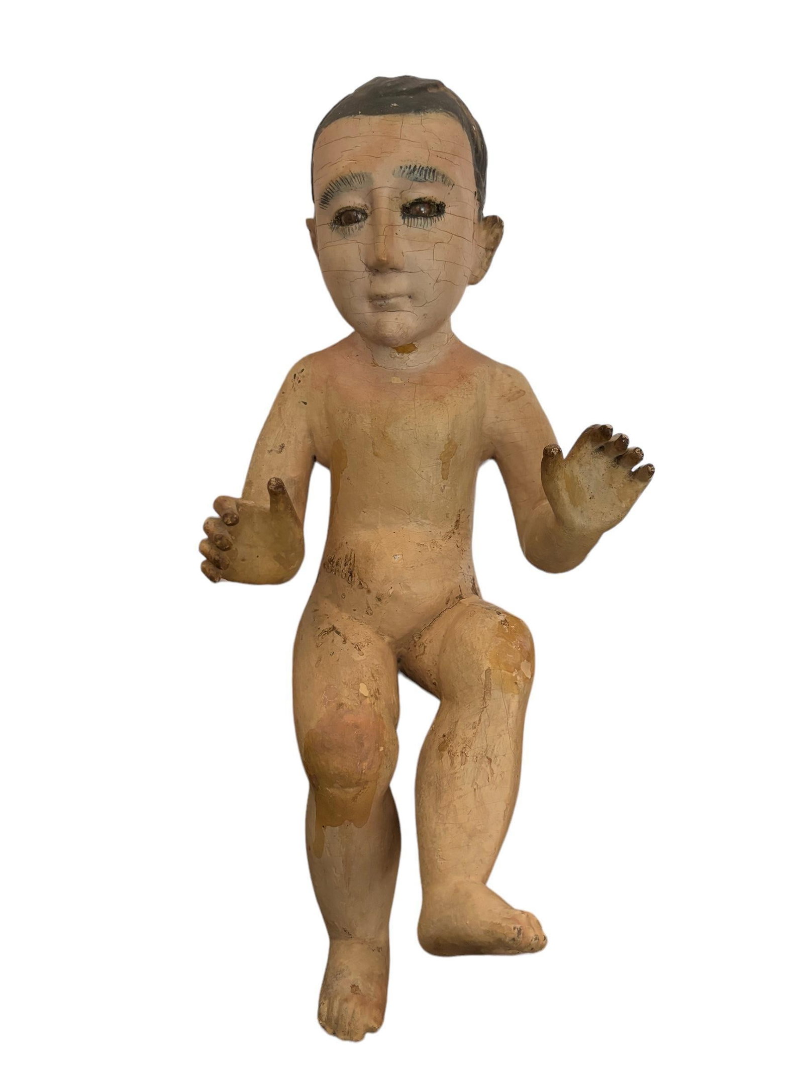 Antique Jesus as Child: Large antique Jesus figure, some crazing, handprinted and glass eyes. 16" tall/long ! Please see terms and conditions for 3rd party shipping/mover information, 15% buyers premium, condition terms, and