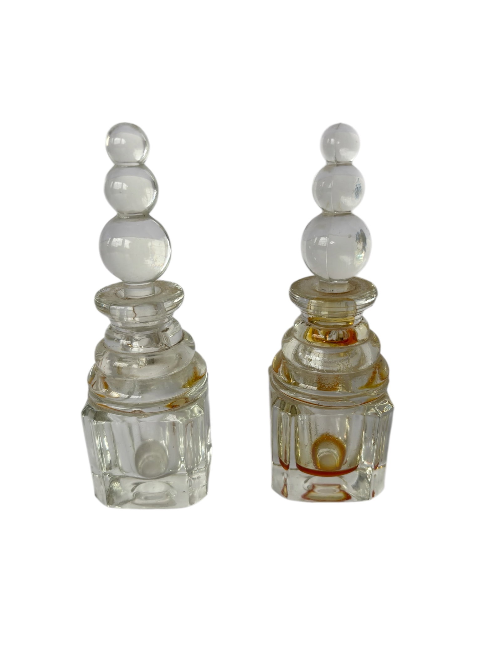 Pair of Art Deco Perfume Bottles: Featuring faceted base and "stacked ball" design toppers.
