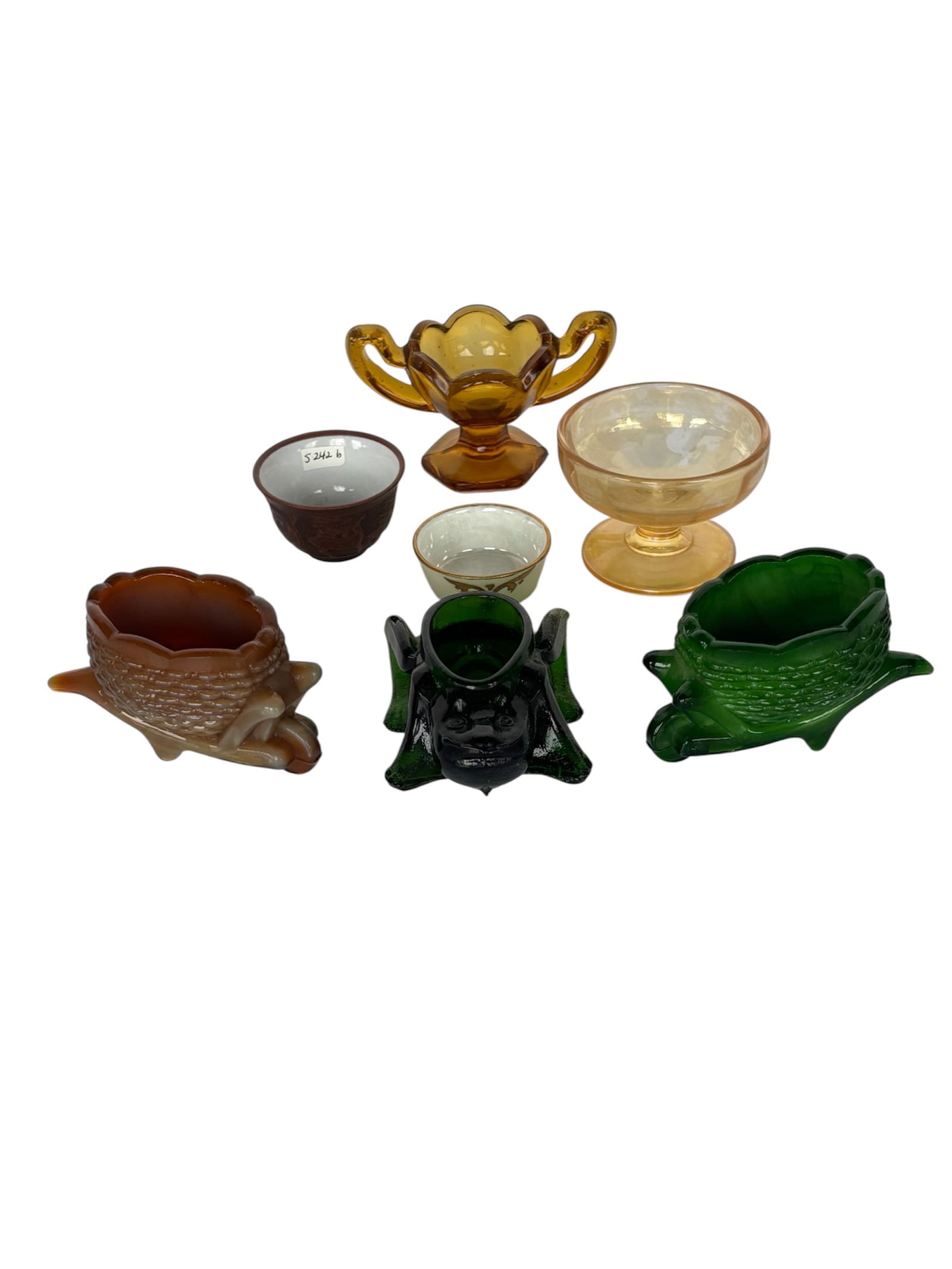Collection of Slag Glass & Art Glass Salt Cellars & More: Including; Joe St. Clair Glass-chocolate slag wheel barrow salt dip or toothpick holder 1970s, forest green slag glass wheel barrow salt dip, amber glass pedestal salt cellar likely Central Glass, ped