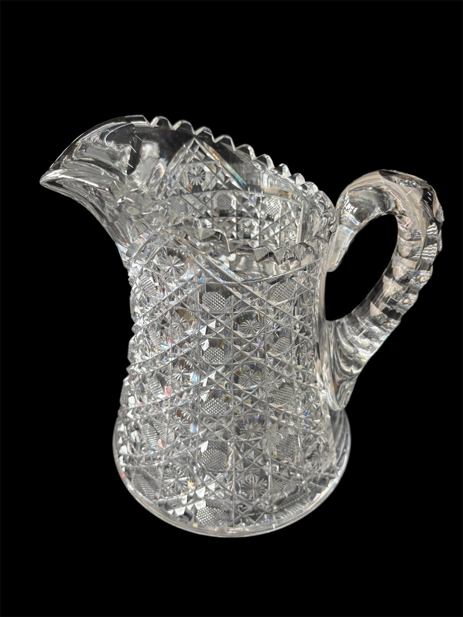 American Brilliant Period Cut Glass Pitcher: Intricate design faceted with geometric patterns.