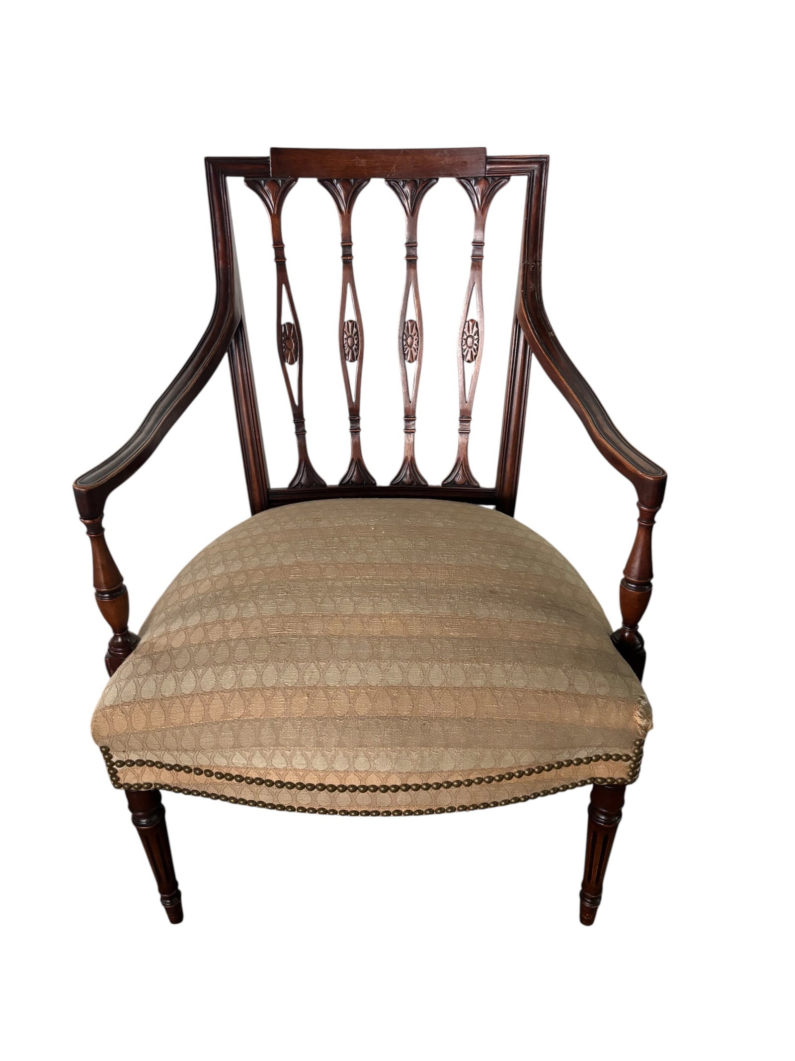 Antique Hepplewhite Style Arm Chair: Late 19th Century-Early 20th century antique chair featuring intricate decorative elements with floral rosettes. Carved details on frame and back, upholstered cushion with nailhead detail on apron. Pu