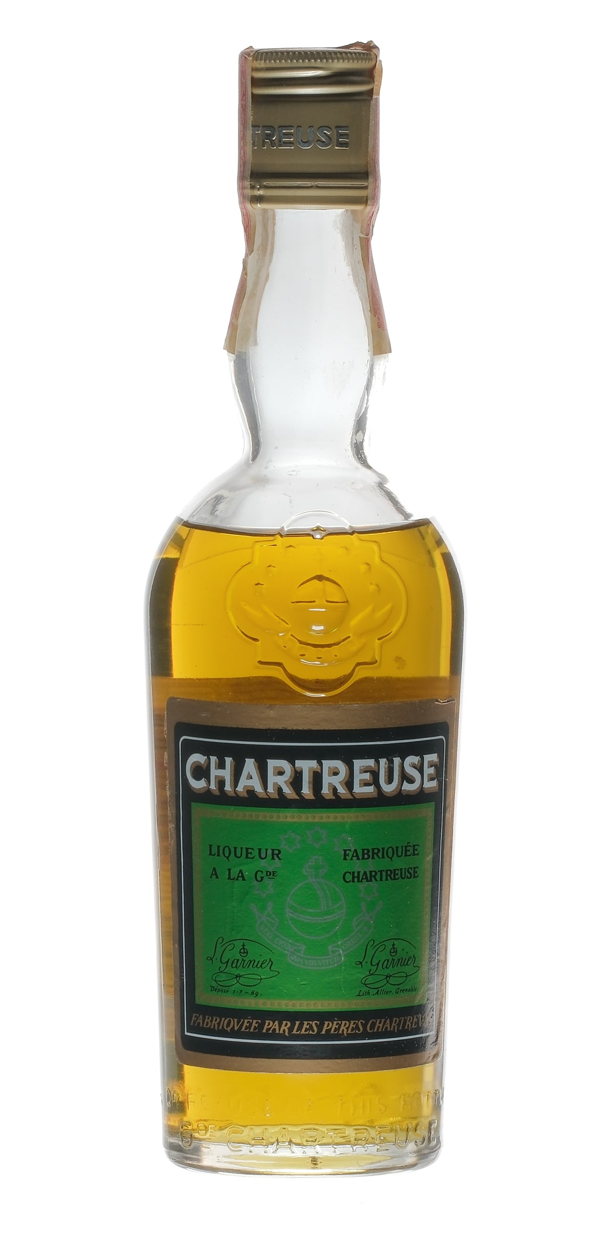 Green Grande Chartreuse Liqueur: Description Vintage Estate Bottle: 110 Proof. Bottle stamp intact over screw top (exhibits some losses). Labels are fair with both exhibiting some nicks (and the rear a good deal of staining). Liqueur