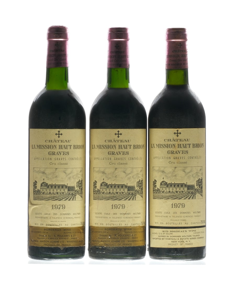 La Mission Haut-Brion Graves Bordeaux 1979: Description Cru classe. Two bottles imported by Maison Jomere Ltd. (Wakefield, MA) and one imported by Cheateau & Estate Wines Company (NY, NY). Cork raised on one bottle. Fill Level = Base Neck. Labe