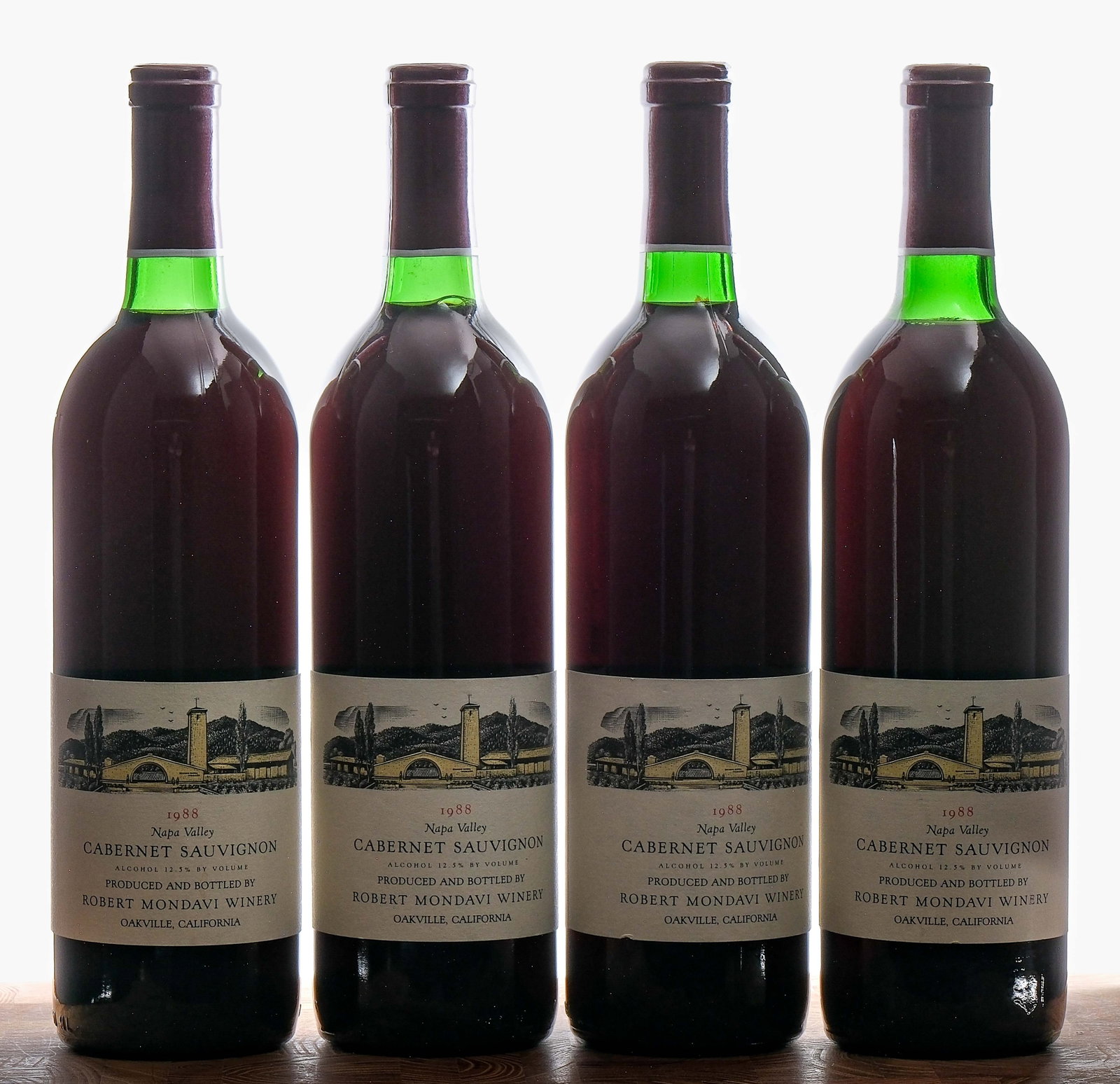 Robert Mondavi Cabernet Sauvignon 1988 Group (4): Group of 4 bottles with a 1988 vintage. Fill level on each is base neck. 12.5% ALC/VOL. Foils excellent. Labels very good (some nicks present). Adhesive residue present on three of the four bottles fr