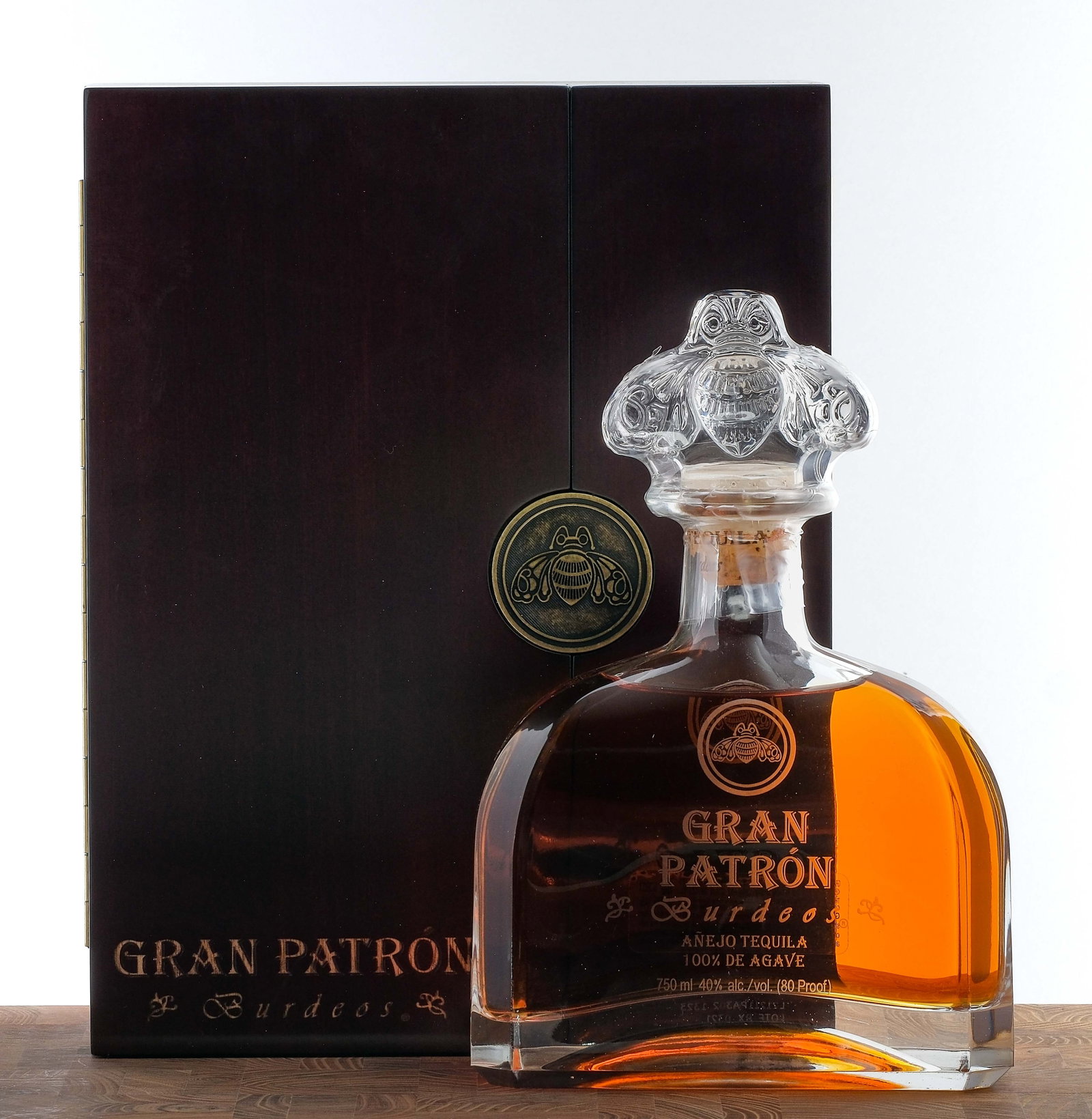 Gran Patron Burdeos Anejo Tequila: No. HP 22211. 40% ALC/VOL (80 Proof). Wooden box in largely excellent condition (some nicks and scratches are present). Plastic seal on bottle intact. Labels excellent. 750ml. The Patron Spirits Compa