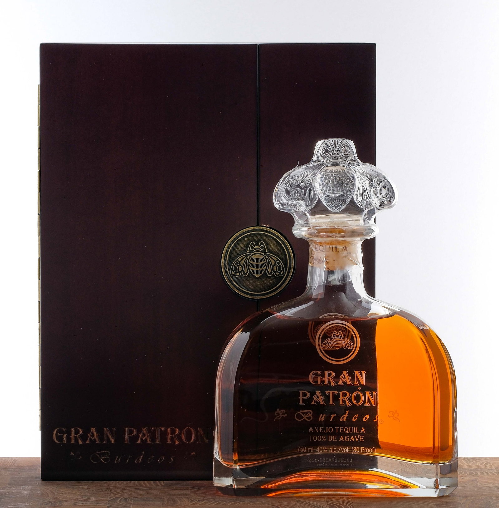 Gran Patron Burdeos Anejo Tequila: No. HP 22211. 40% ALC/VOL (80 Proof). Wooden box in excellent condition. Plastic seal on bottle intact. Labels excellent. 750ml. The Patron Spirits Company.