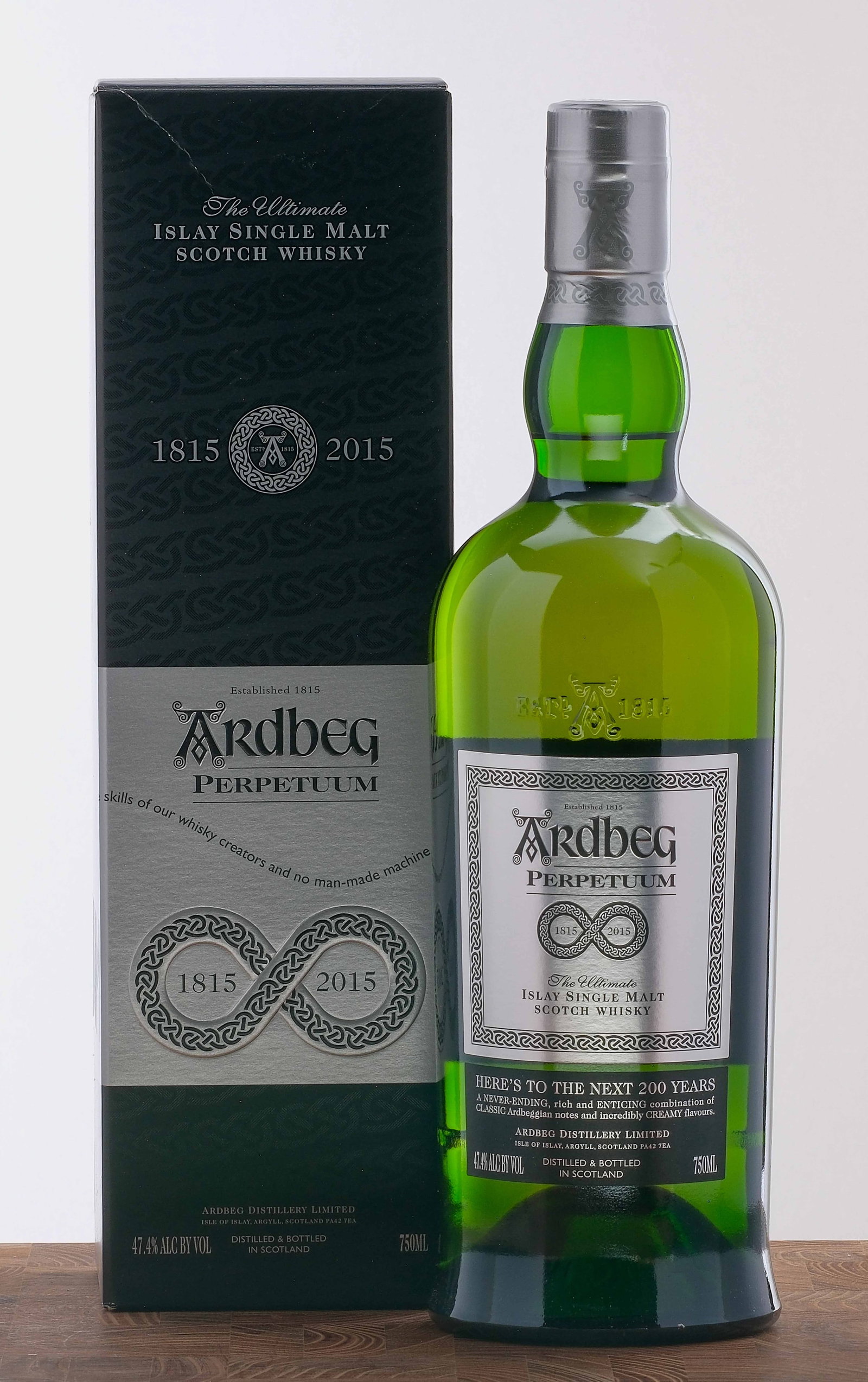 Ardbeg "Perpetuum" Islay Single Malt Scotch 2015: Celebrating 200 years of Ardbeg. 47.4% ALC/VOL. Original cardboard box largely excellent (there is a noticeable crease near the top fold). Foils and labels excellent. 750ml. Ardbeg Distillery Limited.