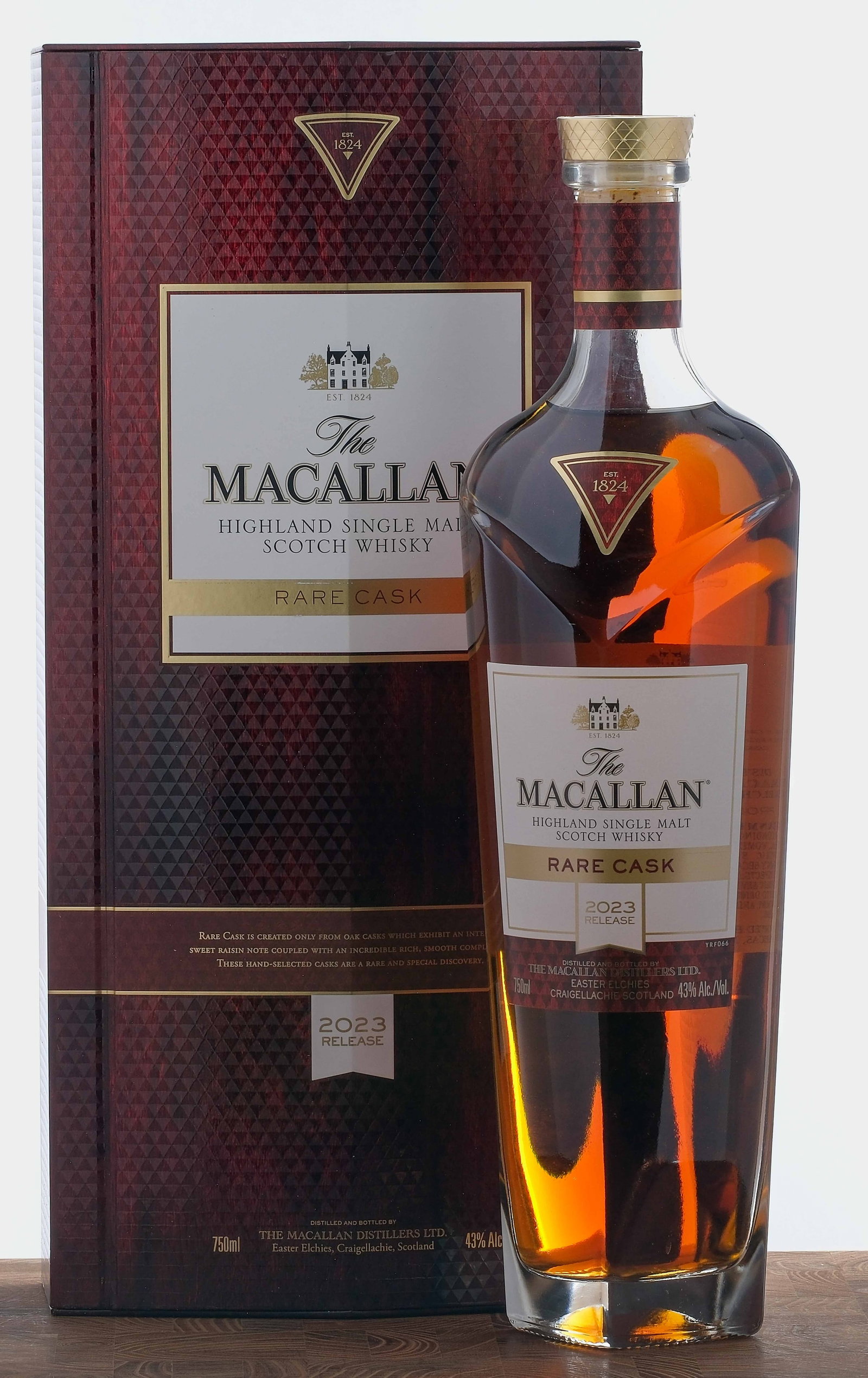 The Macallan "Rare Cask" Single Malt Scotch 2023 Release: Matured in "exceptional oak casks." 43% ALC/VOL. Original cardboard box largely excellent (some losses present on gold foil stamp at front). Included slipcase exhibits two small tears at front and bac
