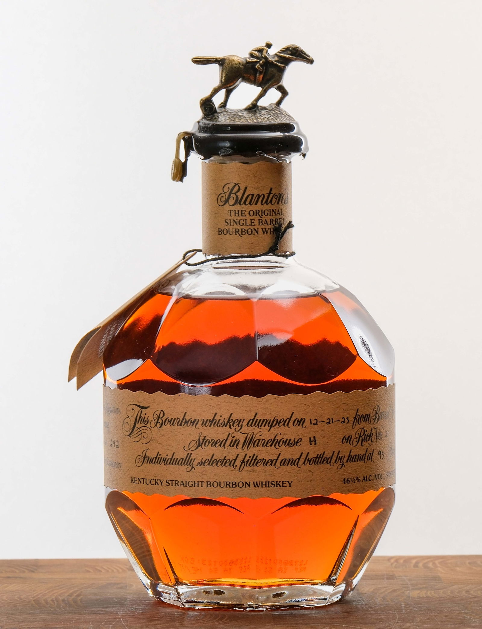 Blanton's Single Barrel Bourbon 2023: Dumped on 12-21-23 from Barrel No. 1111. Stored in Warehouse H on Rick No. 2. Registered Bottle No. 242. 46.5% ALC/VOL (93 Proof). Wax seal intact (one of the tabs is slightly askew). Hang tag intact.