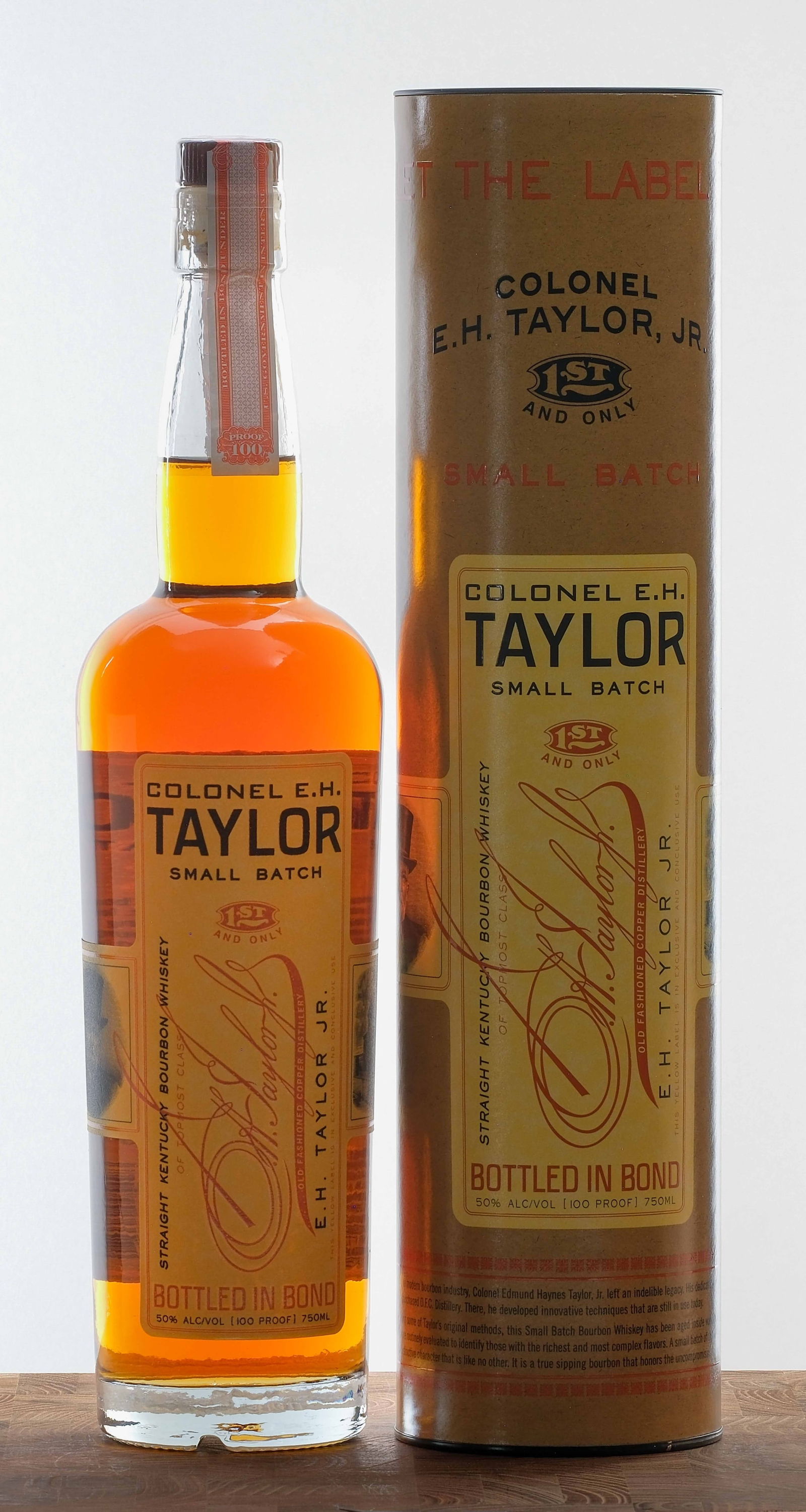 E.H. Taylor Small Batch Straight Kentucky Bourbon: 50% ALC/VOL (100 Proof). Original cardboard tube excellent. Plastic seal on bottle intact. Labels excellent. 750ml. Old Fashioned Copper Distillery.
