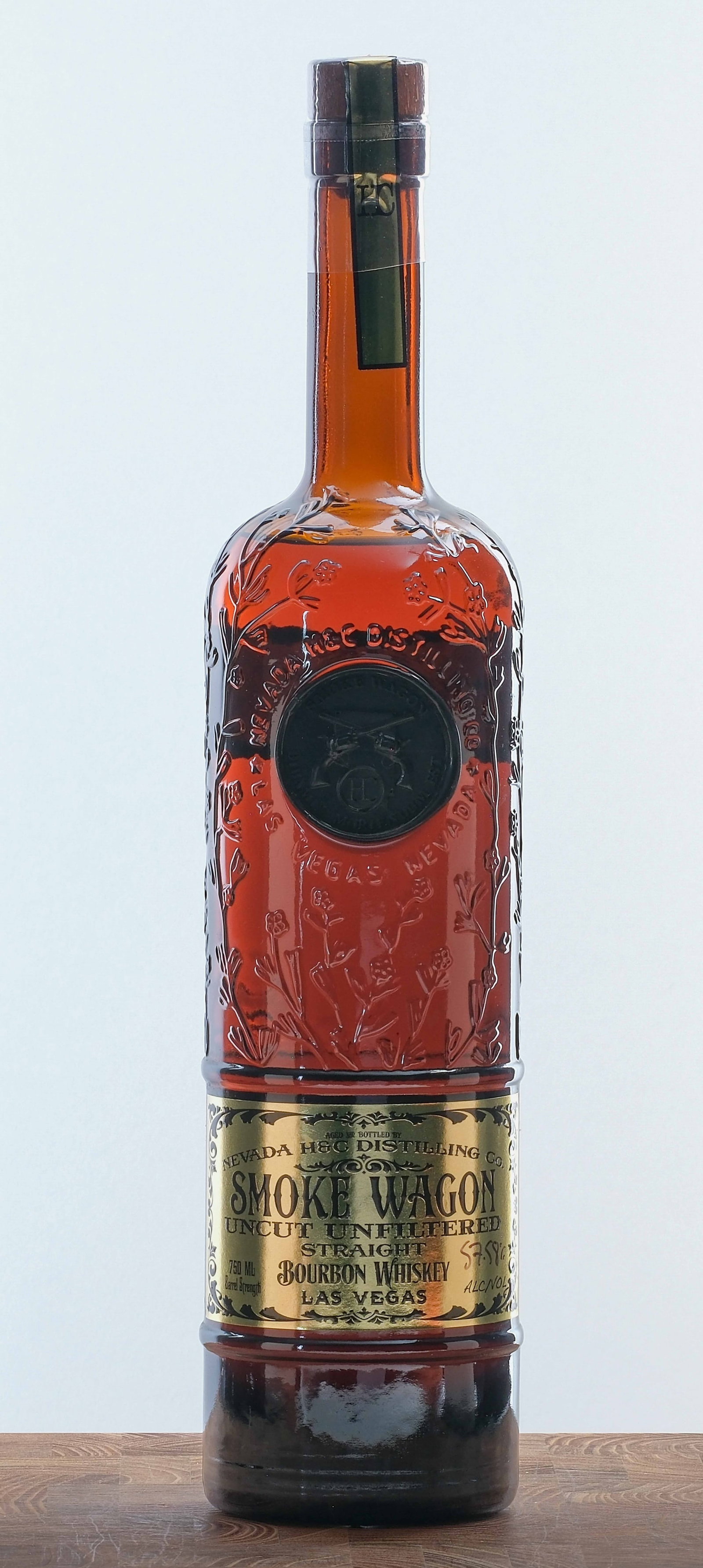 Smoke Wagon Uncut Unfiltered Straight Bourbon 2022 Batch 141a: Batch Number 141a. 57.58% ALC/VOL (115.16 Proof). Plastic seal and stamp intact. Wax medallion and labels excellent. 750ml. Nevada H&C Distilling Co.
