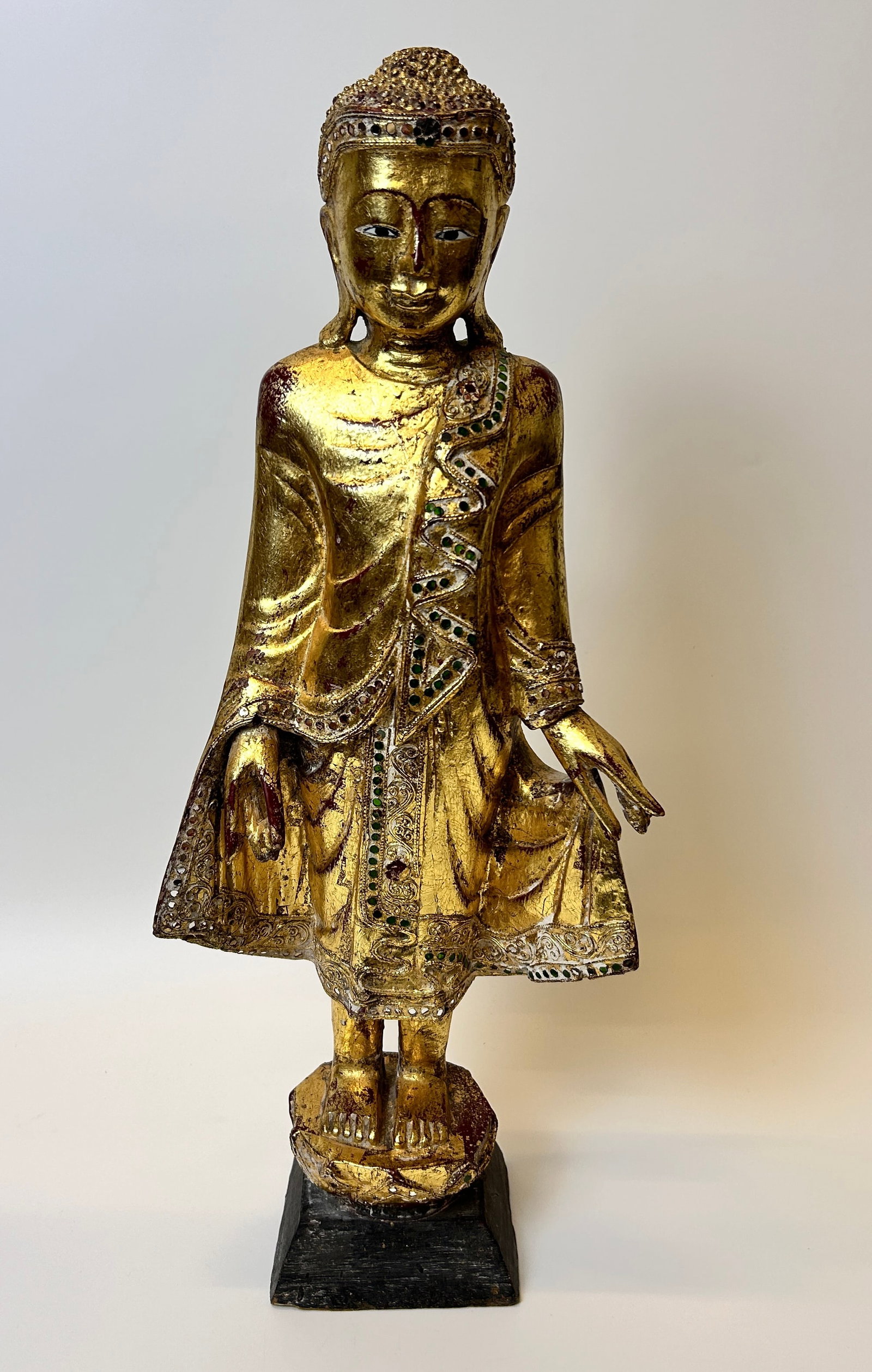 Standing Gold Buddha with colored stones: Standing Gold Buddha with colored stones DIMENSIONS: 9 W x 24 H inches The live auction begins at 11 AM EST Saturday, May 25th. Full condition reports are available before the auction by e