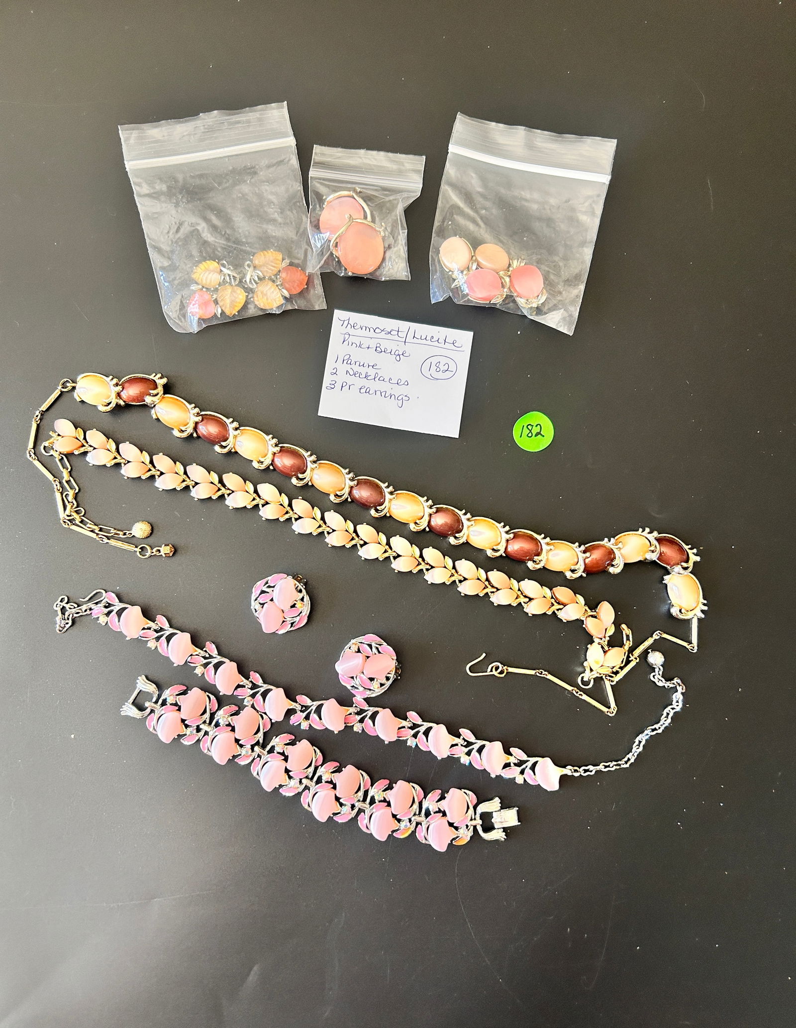 MCM Thermoset/Lucite Pink Beige:1 Parure, 2 Necklaces, 3 PR Earrings: DESCRIPTION: MCM Thermoset/Lucite Pink Beige:1 Parure, 2 Necklaces, 3 PR Earrings 1 Parure, 2 Necklaces, and 3 Pair of Earrings Thermoset / Lucite - Pink and Beige MEASUREMENTS IN INCHES AR