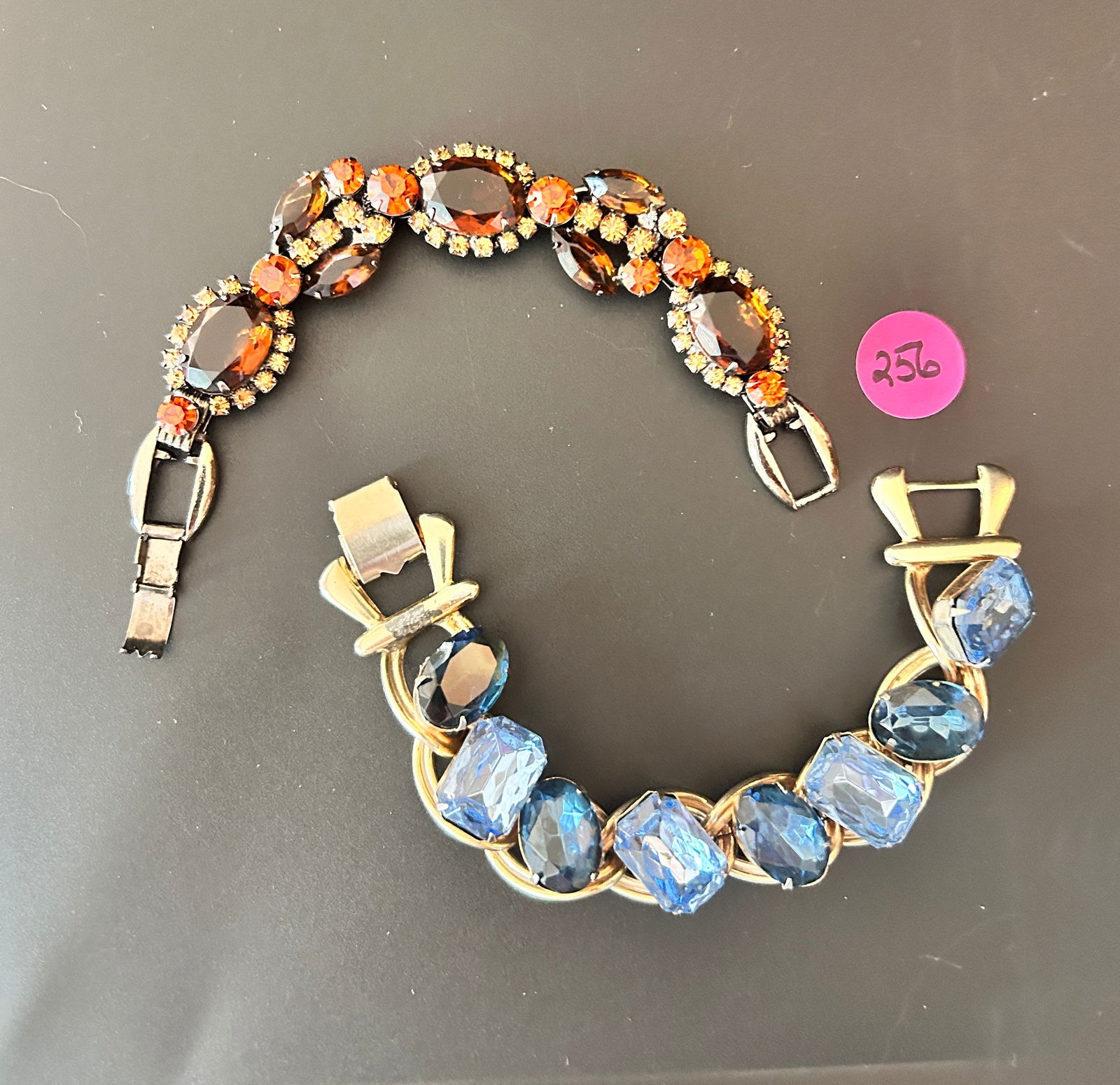 2 Juliana Style bracelets: DESCRIPTION: 2 Juliana Style bracelets Root beer orange cinnamon R/S open backed stones chunky blue R/S MEASUREMENTS IN INCHES ARE