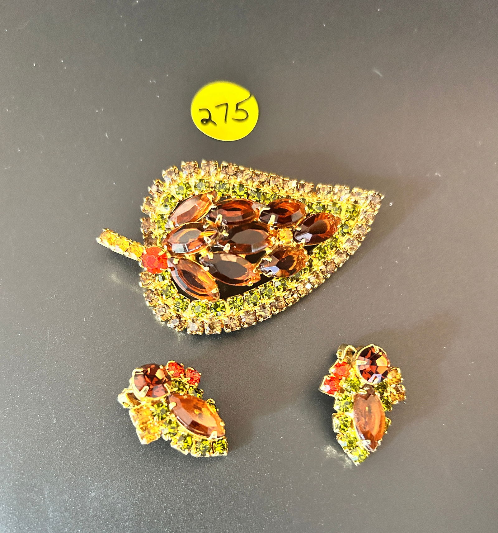 Juliana Set Brooch & Earrings Leaf amber peridot orange: DESCRIPTION: Juliana Set Brooch & Earrings Leaf themed amber peridot orange R/S and amber Navette R/S MEASUREMENTS IN INCHES ARE DISPLAYED IN THE PHOTOS CONDITION: GOOD