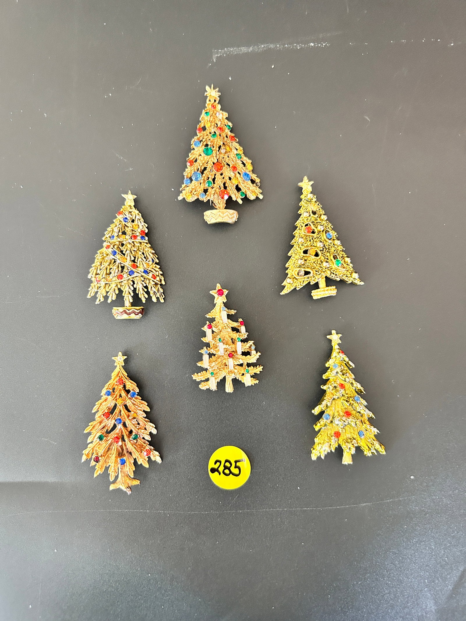 6 Arthur Pepper Christmas Tree Brooches: DESCRIPTION: 6 Arthur Pepper Christmas Brooches MEASUREMENTS IN INCHES ARE DISPLAYED IN THE PHOTOS CONDITION: one stone lost, otherwise good JOIN US ONLINE