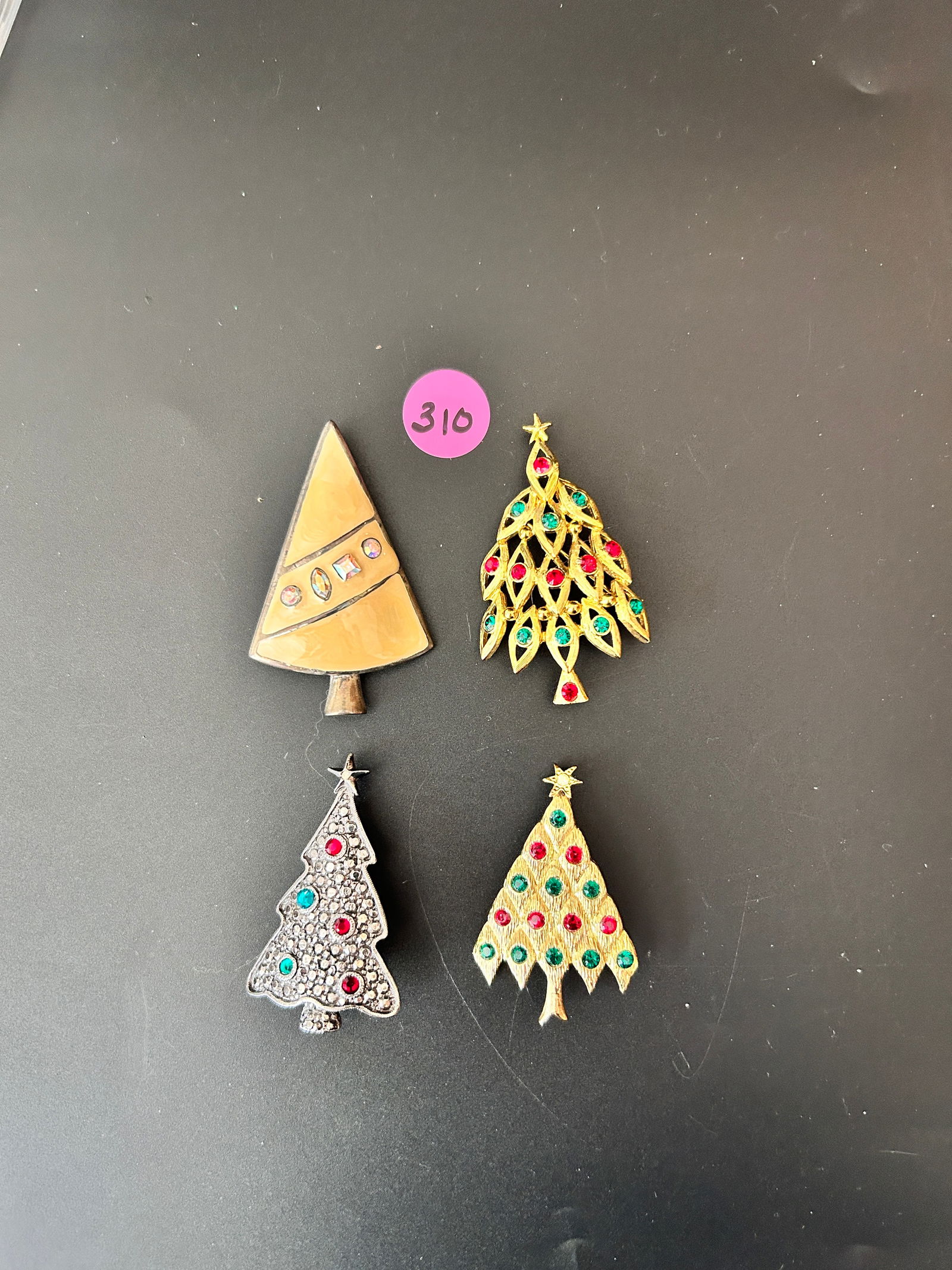 4 Lia Lianna Christmas Tree Brooches, 2 Goldtone, 1 enamel 1 pewter metal: DESCRIPTION: 4 Lia Lianna Christmas Tree Brooches, 2 Goldtone, 1 yellow enamel 1 pewter metal w/R/S MEASUREMENTS IN INCHES ARE DISPLAYED IN THE PHOTOS