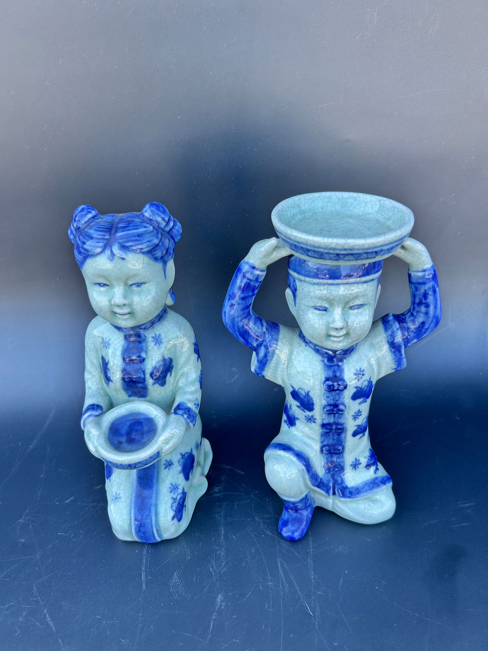 Pair modern Chinese seated figures in shades of blue: Pair modern Chinese seated figures in shades of blue measures in inches: 4 W x 9.5 H condition: good IN-HOUSE SHIPPING AVAILABLE PLEASE EMAIL: longlakeart@gmail.com for more info.