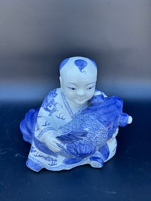 Chinese ceramic figure of boy holding koi - blue/white