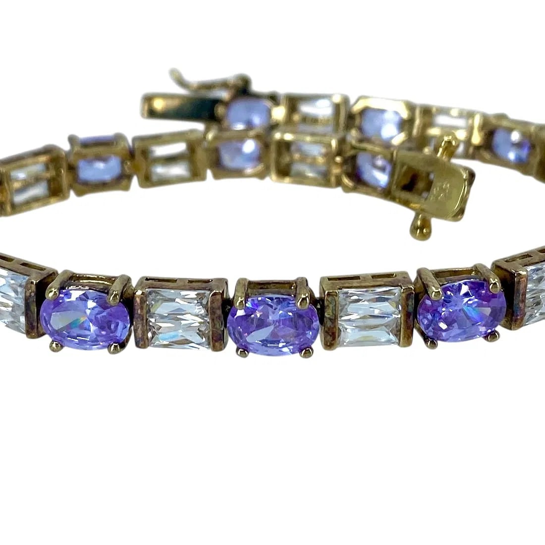 Stunning Purple Oval and Clear Baguette Rhinestone Gold Over Sterling Silver Signed Tennis Bracelet: Stunning Purple Oval + Clear Baguette Rhinestone Gold Over Sterling Silver Signed Tennis Bracelet, 7.75in, 18.87, Engraved "C'o 925In-house domestic shipping is available, email for more information.