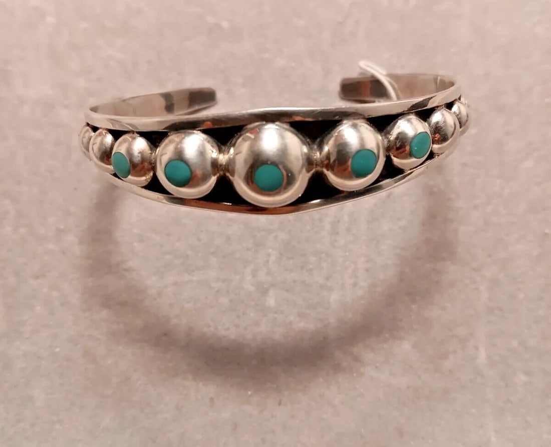 Sterling turquoise cuff bracelet ~ Navajo 925: Sterling turquoise cuff bracelet ~ Navajo 925 Turquoise stones set in sterling, detail at open ends.Size: 3" w x 2.5" Circumference: 2.5" Gap opening 1.0" adjustable. - In-house domestic shipping is a