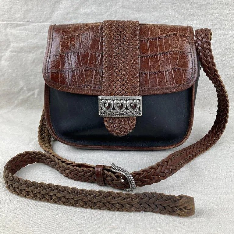 Vintage Brighton Black Brown Woven Silver Hardware Shoulder Bag: Black leather crossbody bag featuring a brown crocodile leather flap accented with a decorative heart concho and a hanging heart fob, finished with silvertone hardware and a rustic braided adjustable