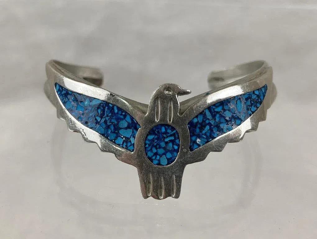 Vintage Thunderbird Cuff Bracelet ~ Sterling marked Mexico [14g]: thunderbird motif accented by turquoise chip inlay across the wings and body and is stamped Mexico. The floral bracelet measures approx. 1 3/4" H x 2 1/2" W, marked Mexico, sterling===================