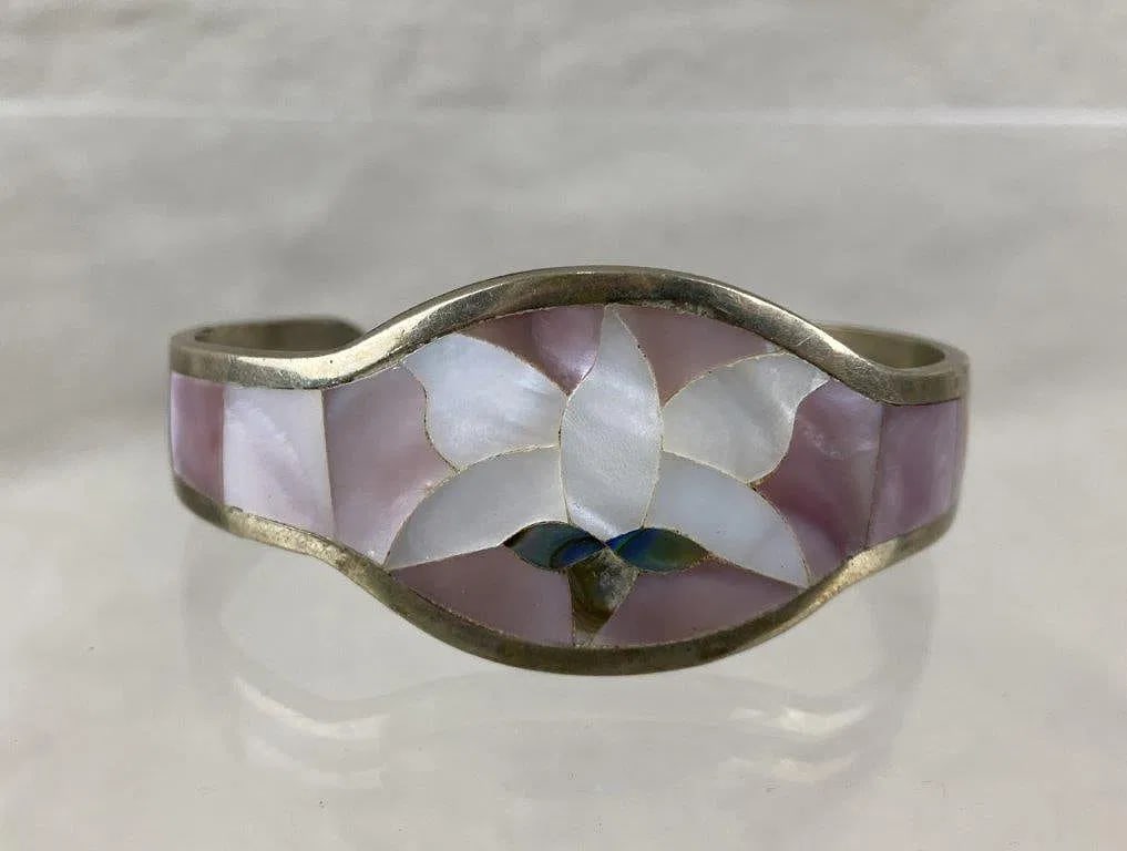 Vintage Floral Cuff Bracelet marked sterling [20g]: gold-tone band featuring a floral inlay of mother-of-pearl and abalone shell This floral bracelet measures approx. 1 3/4" H x 2 1/2" Wwgt 20g=======================================
