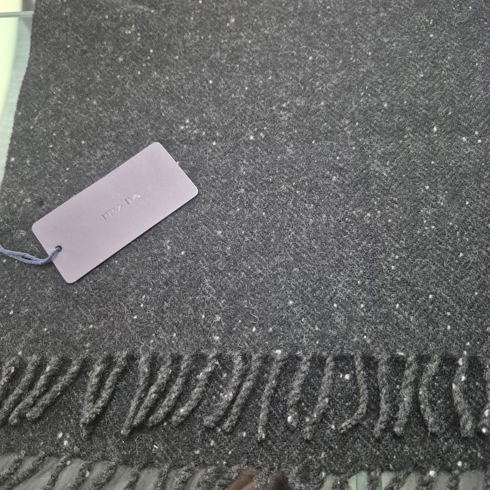 Original PRADA 100% WOOL Scarf ~ NEW never Worn [NIB]: Original PRADA 100% WOOL Scarf ~ 12x58Charcoal grey flecked wool scarf with fringes100% Merino Wool as listed on the Prada Catalogue.NEW....Never Worn / in original bag w/ tag