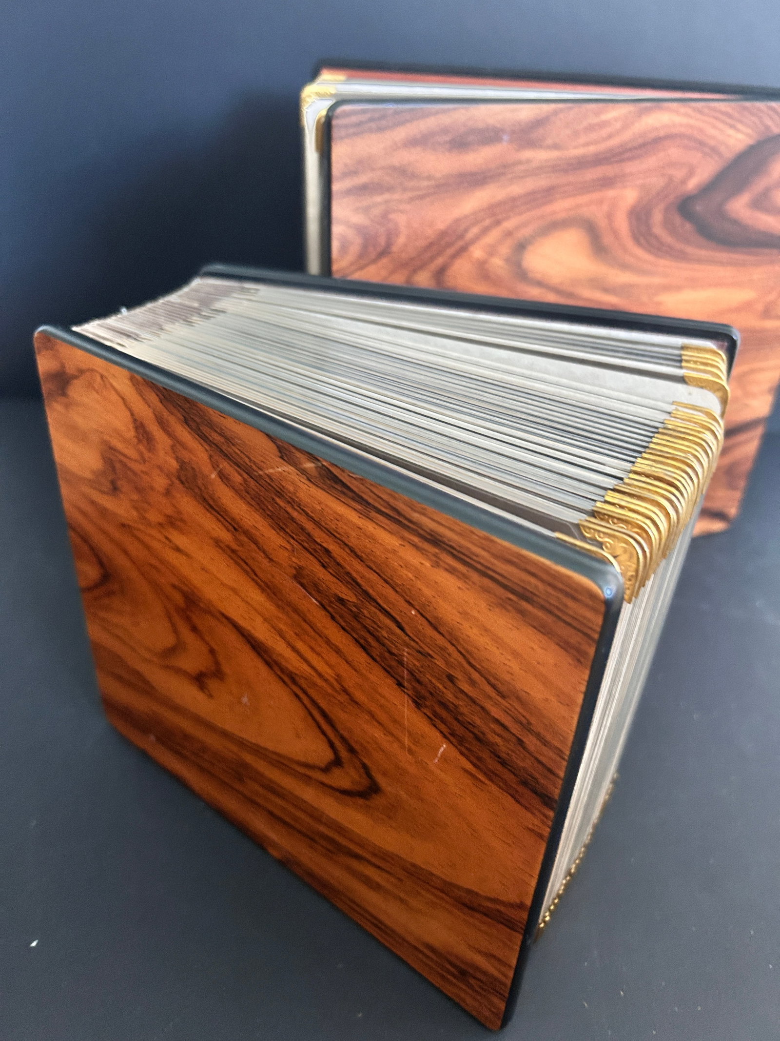 2 Wood Covered Photo Albums "Photo Curio" gold hinged pages: 2 Wood Covered Photo Albums "Photo Curio" gold hinged pages, small measures 6.25 H x 7.25 Wx 3 D in inches, small photo albu,n opening is 4.5 x 4.5 inches fits up to a 6 x inch photo. Second album 8.5