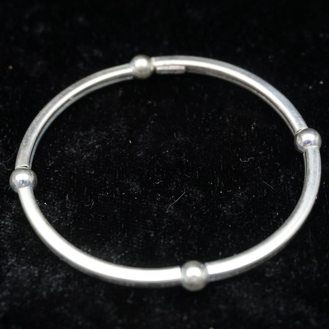 Sterling Silver 2" Expanding Bangle Bracelet w/ Bead Accents | 6.7g: Sleek sterling silver expanding bangle bracelet featuring a minimalist tubular design with evenly spaced polished bead accents. The flexible, expanding style allows for easy on and off while maintaini