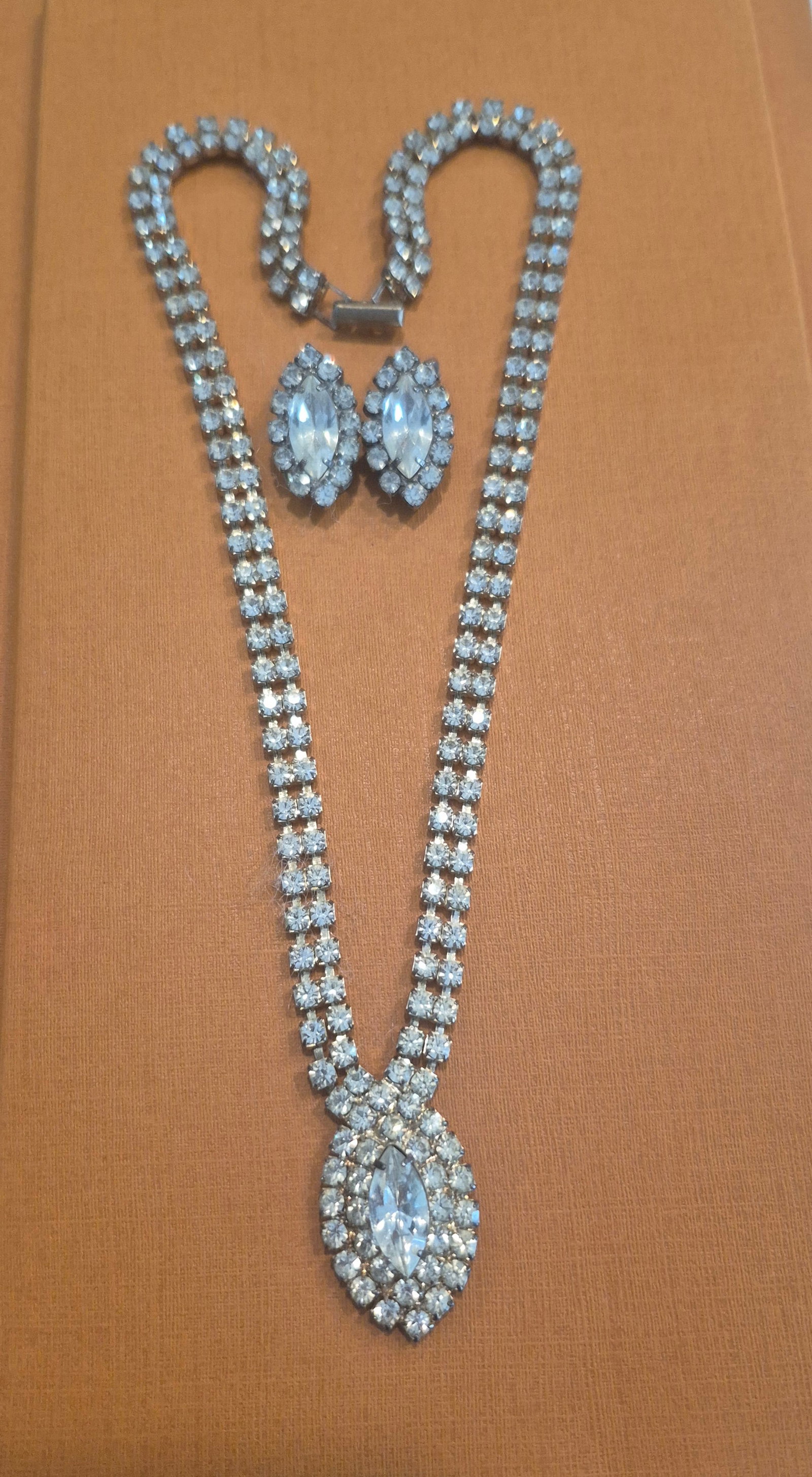 Emons MCM Swarovski Rhinestone Necklace & Earring Set: Emons MCM Swarovski Rhinestone Necklace & Earring Set> rhodium plated chain prong set with round cut brilliant rhinestone, culminates in a centerpiece multi-faceted marquisecut crystal accented by sma